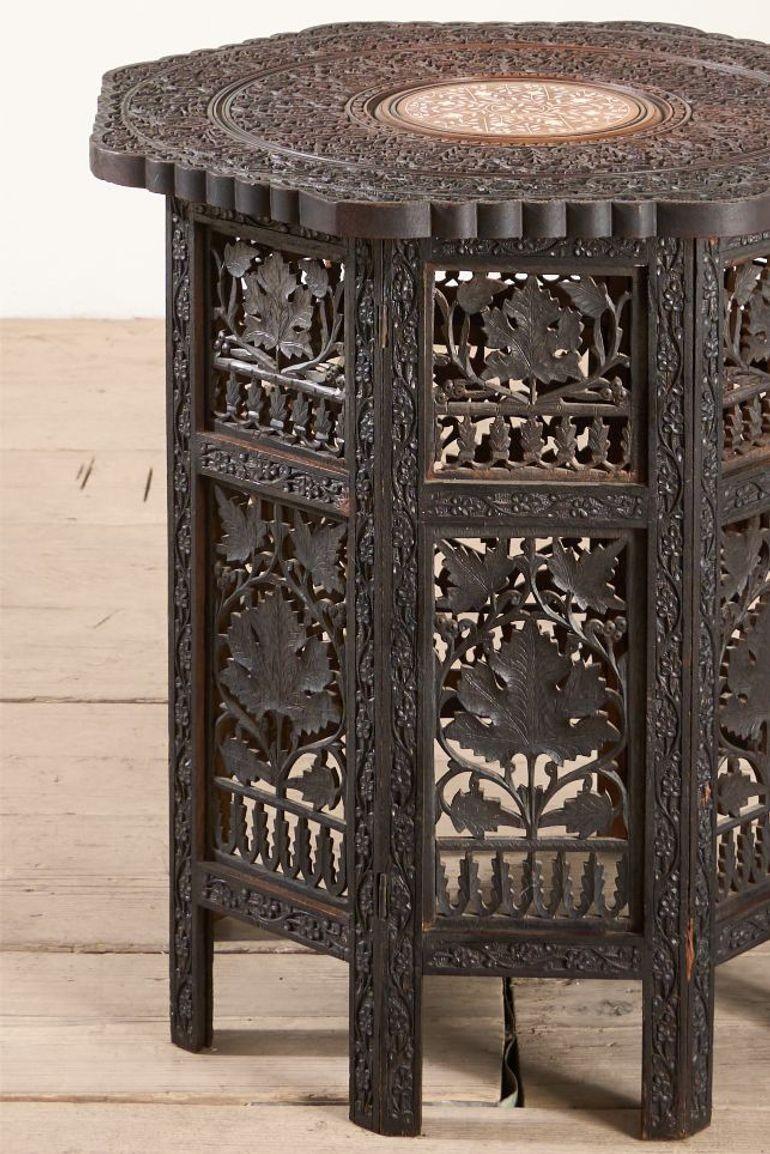 This is a very nice quality, totally original 19th century Padauk Anglo-Indian side table. The finely carved top is exceptional quality with the striking bone inlaid centre circle contrast. The base us also very nicely carved and overall is in