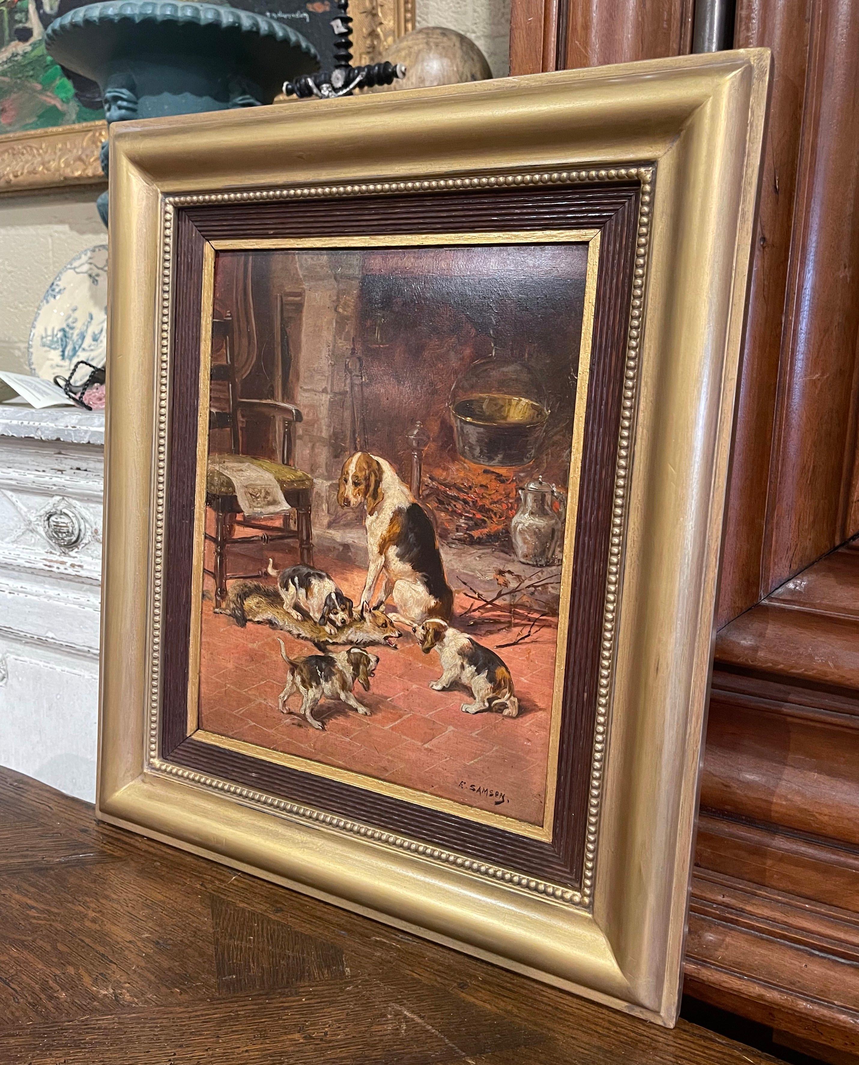 The canvas was hand painted in France circa 1880. Set in the original carved oak and gilt wood frame, the composition features an interior scene with a beagle mother attending her puppies. The artwork is signed on the bottom right corner by French