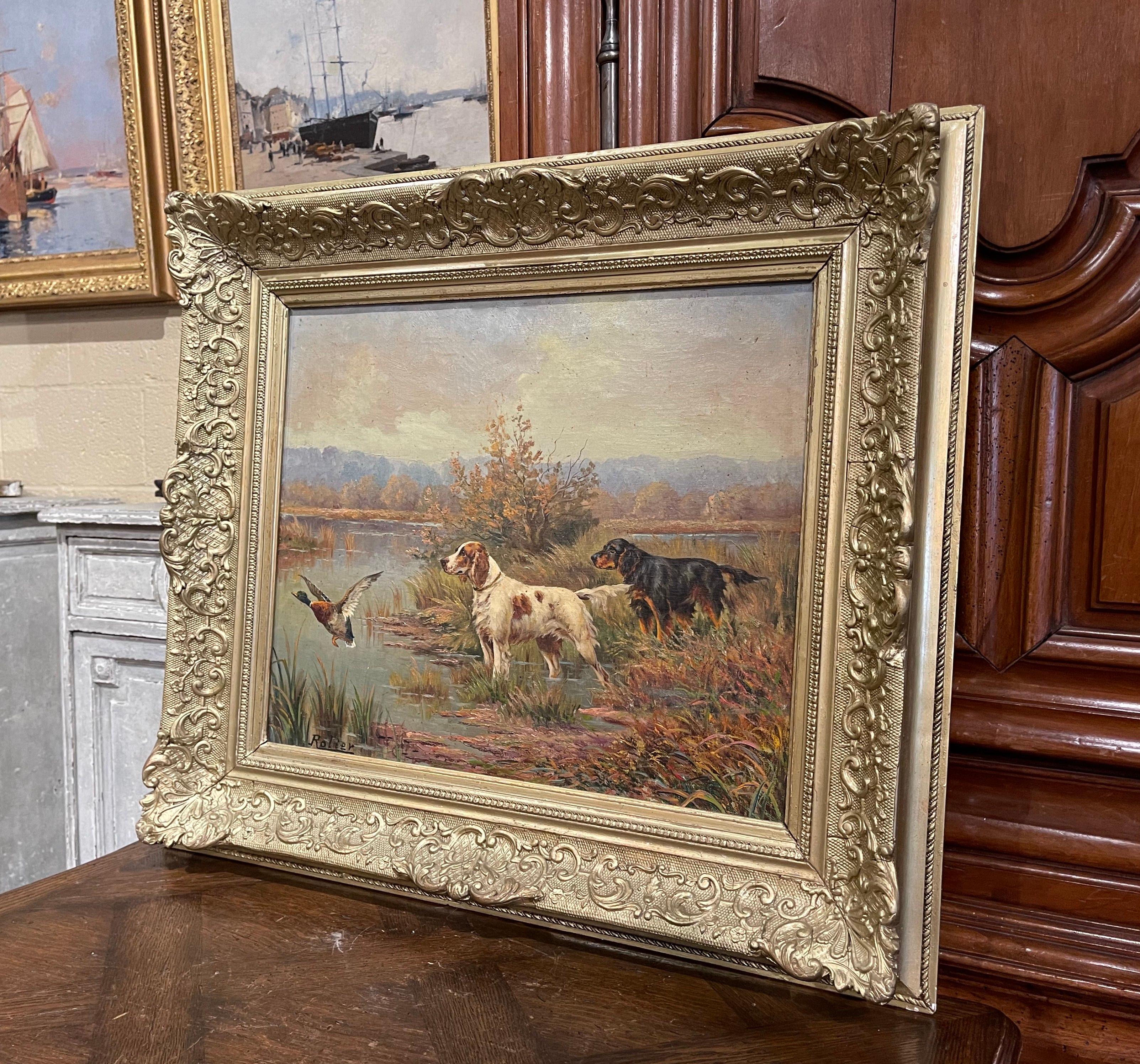 Decorate a study or a den with this colorful antique dog painting. Set in the original Louis XV style carved gilt wood frame, this large painting was created in Belgium circa 1880; the subject composition depicts two spaniels in the field and