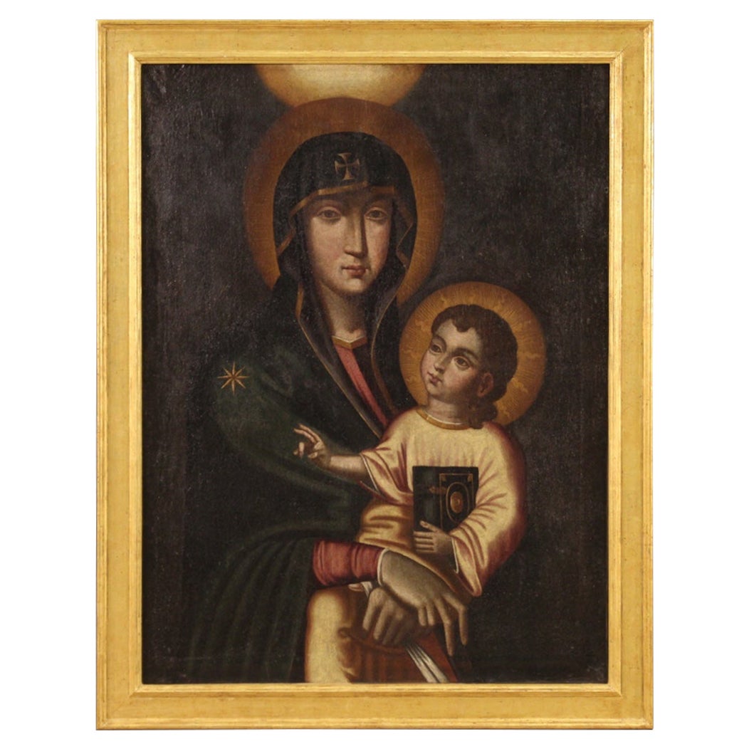 Peinture italienne de la fin du 19e siècle / début du 20e siècle. Oeuvre d'art à l'huile sur toile représentant la Vierge à l'enfant dans un style byzantin antique de bonne qualité picturale. Cadre en bois du XXe siècle, sculpté et doré, de belle