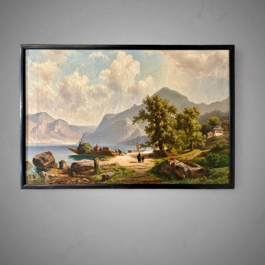 This sublime and enchanting scene reveals itself amid a picturesque landscape of lakes and mountains, imbued with the gentle embrace of warm hues. It is an oil-on-canvas painting from the late 19th century, painted by German landscape painter of the
