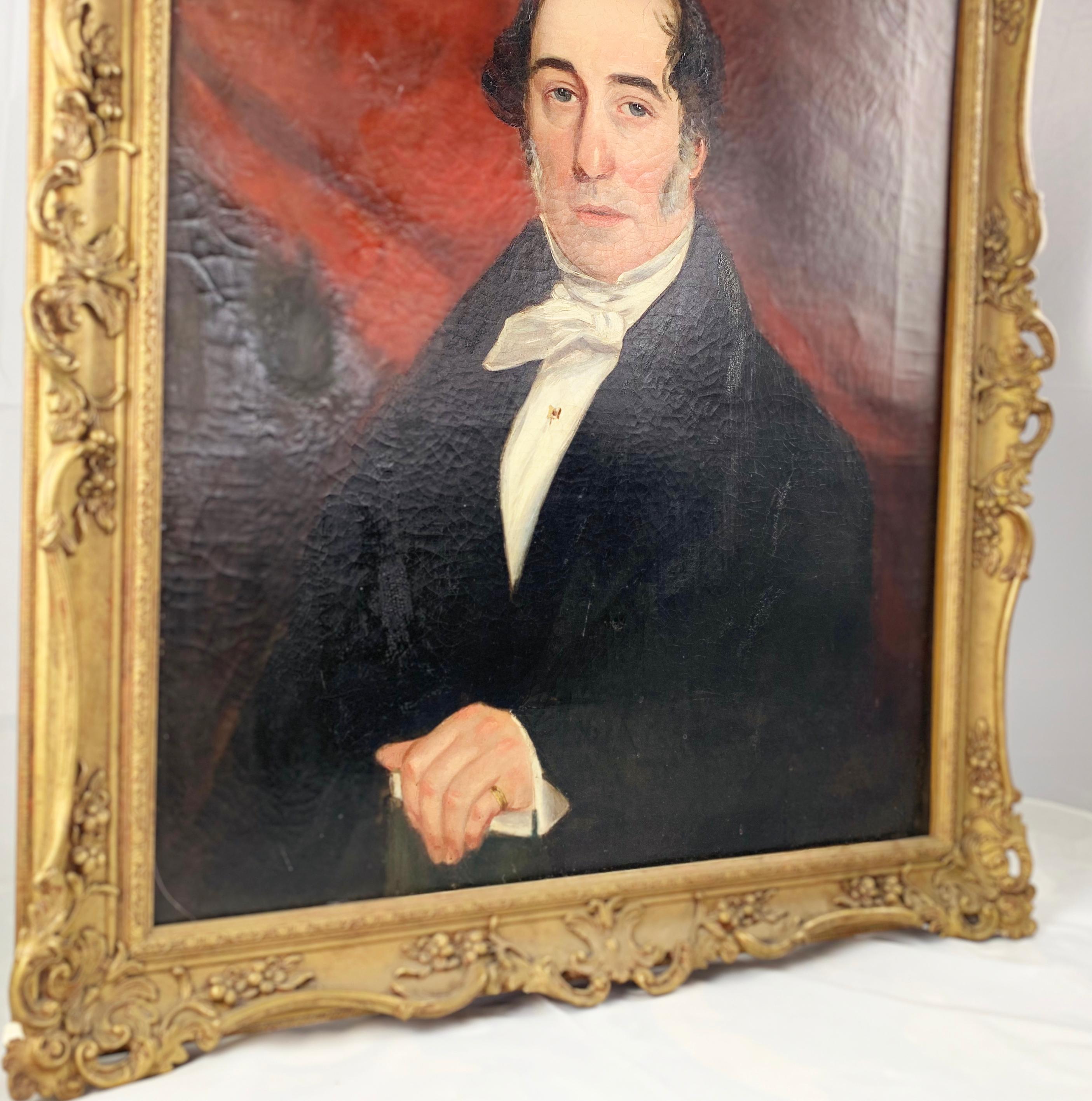 19th century English School. Oil on canvas. Half-length portrait of a Gentleman. Wearing a black jacket with white bow tie. In a carved giltwood frame.