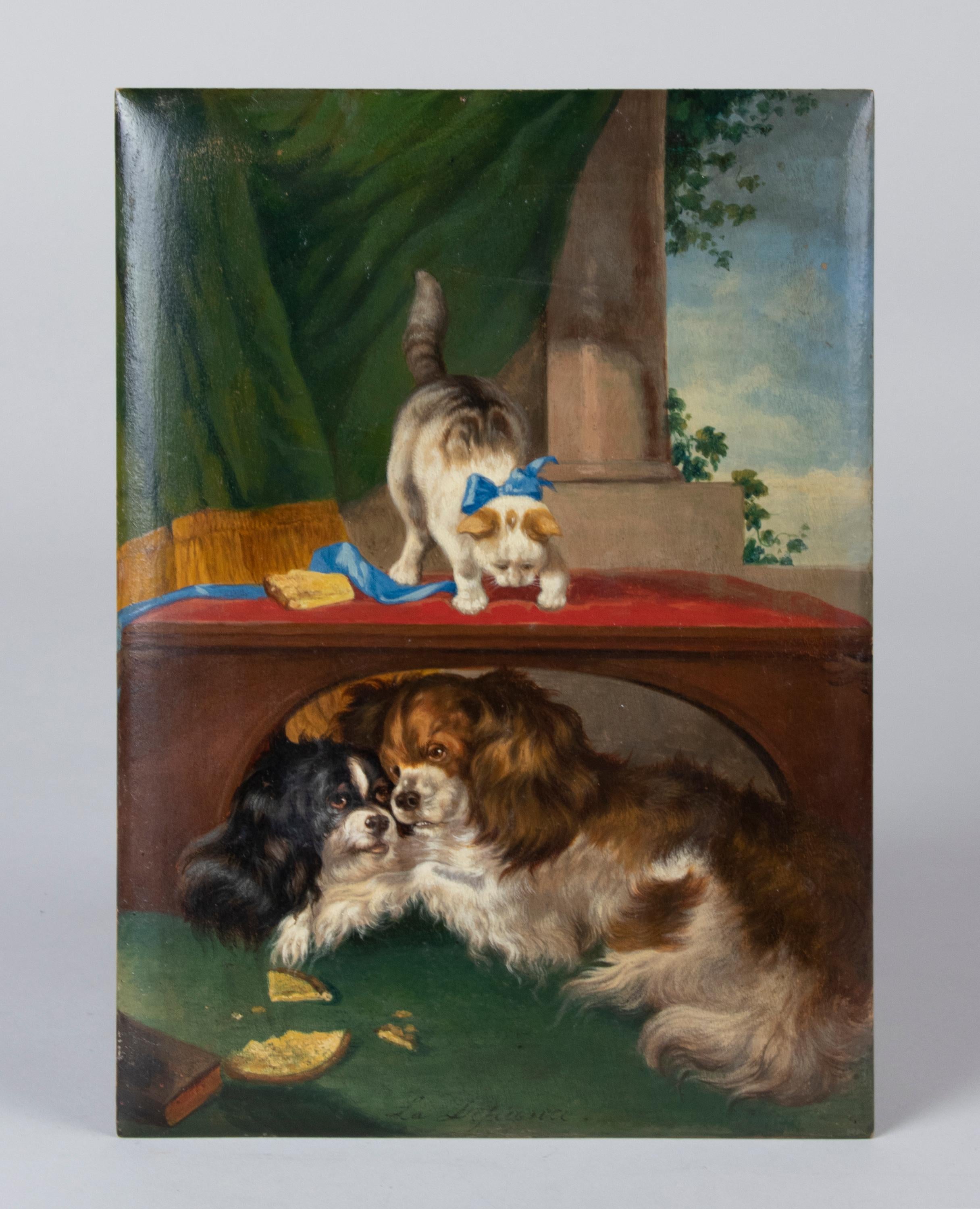 Beautiful antique painting, oil on panel, depicting two King Charles Cavalier Spaniels and a cat.
It is a lovely painting, not too big, with beautiful bright colours. At the bottom is the title: 'La Defiance', which means 'the resistance'. The