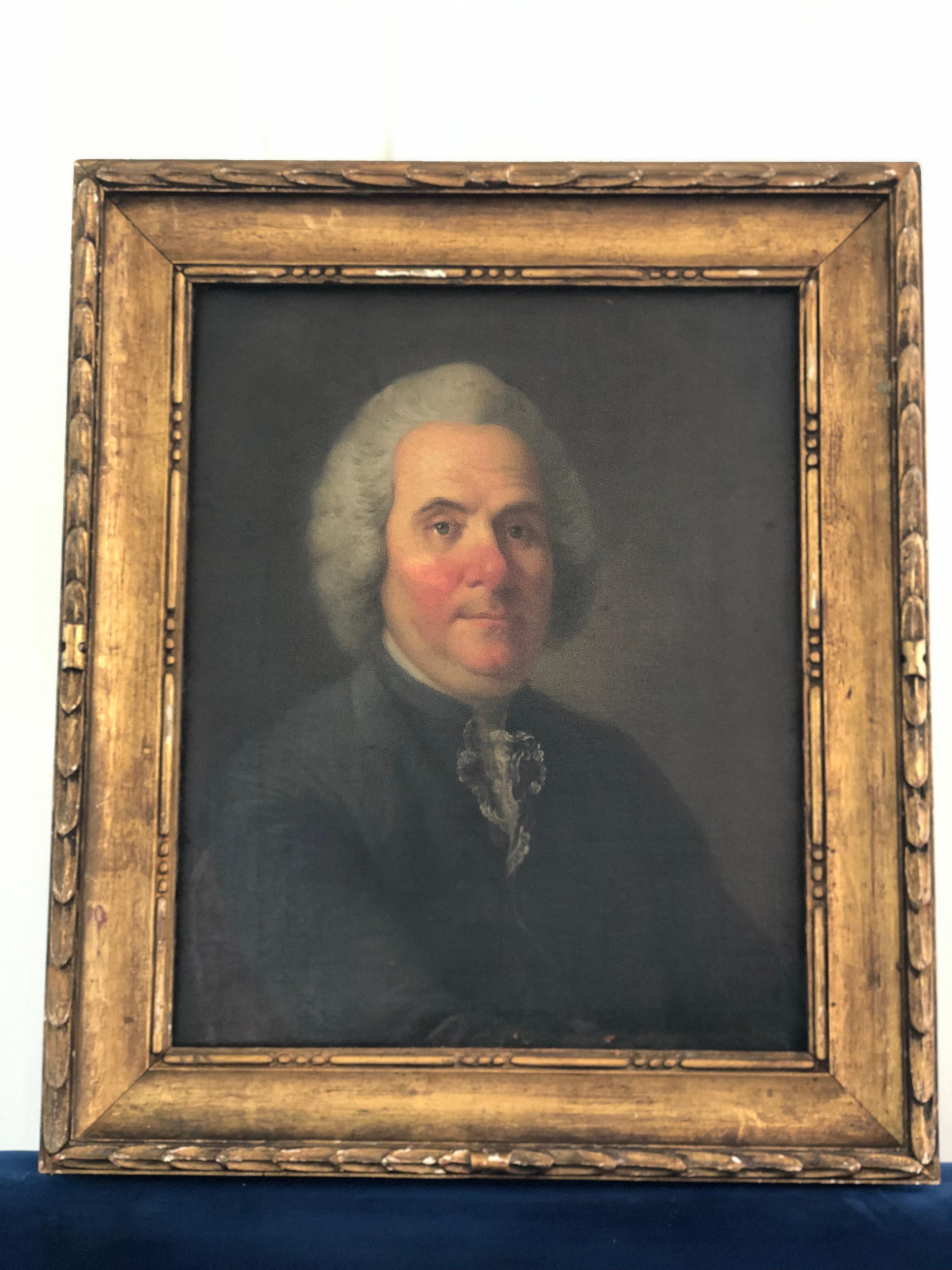Enhance your home with this unique 19th-century portrait painting of an esteemed gentleman with striking blue eyes. Characterized by his rosy cheeks, nose, and chin (either by birth or too much wine). The portrait is set in a beautifully aged gilded