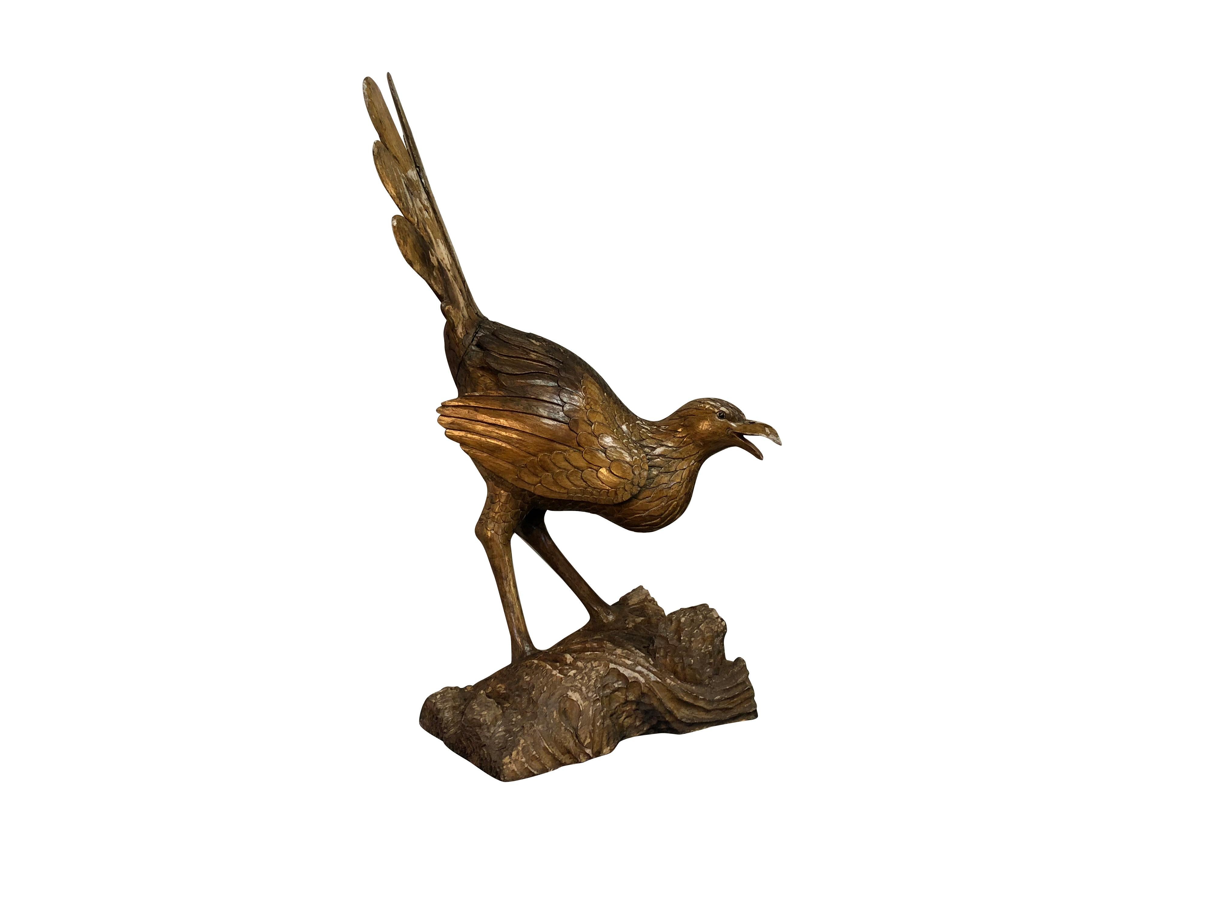 A gold, antique French hand carved mythological bird made entirely of Cypresswood, very detailed craftsmanship and carving. The large table décor is in good condition. Wear consistent with age and use, circa 1860, France.