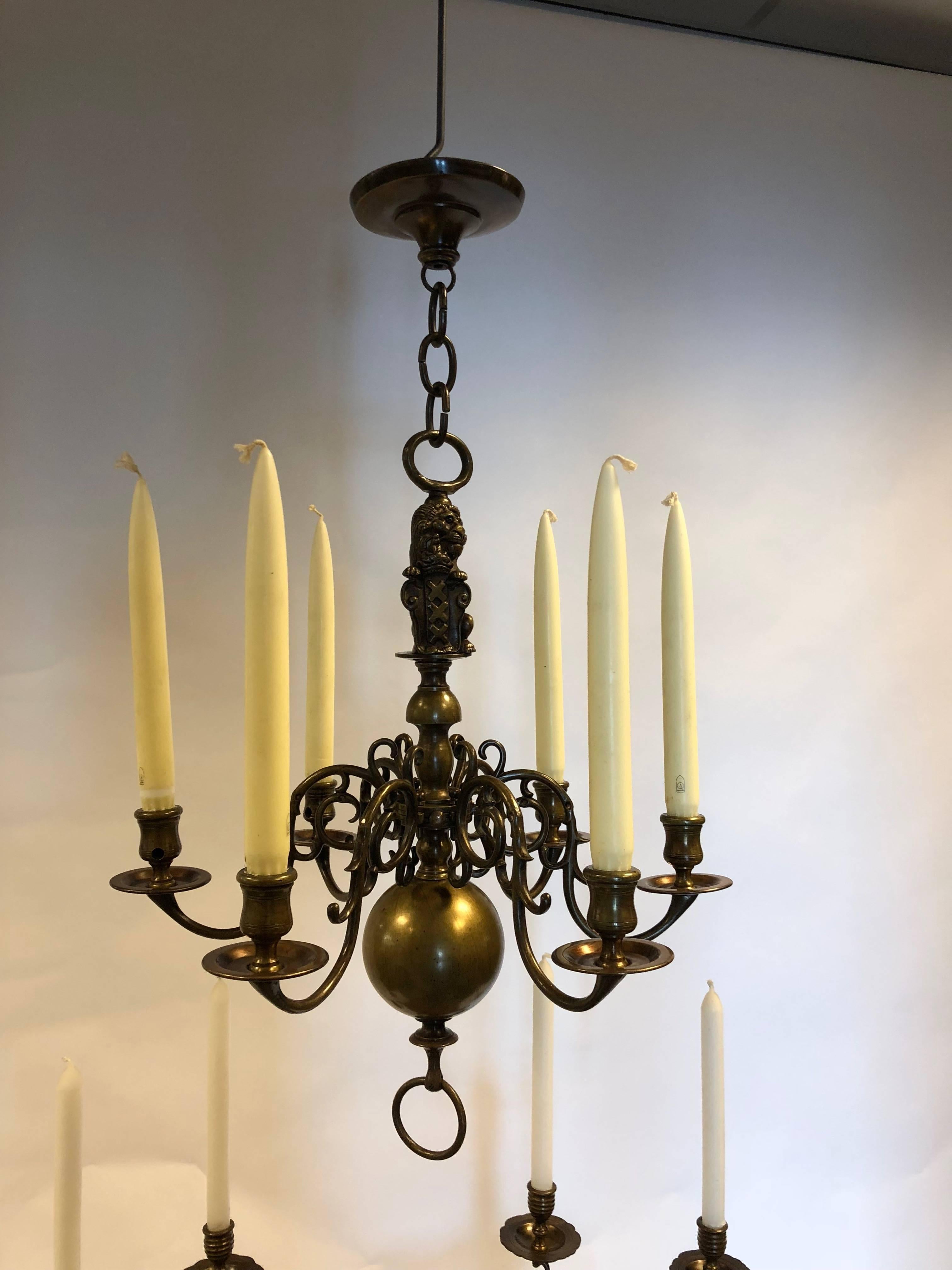 An six-lights antique bronze old Dutch chandelier with coat of arms from Amsterdam.
And a couple of bronze two-light candleholder with the coat of arms of Amsterdam from the 19th century.
Dimensions candleholders heights 25cm x wide 24cm.