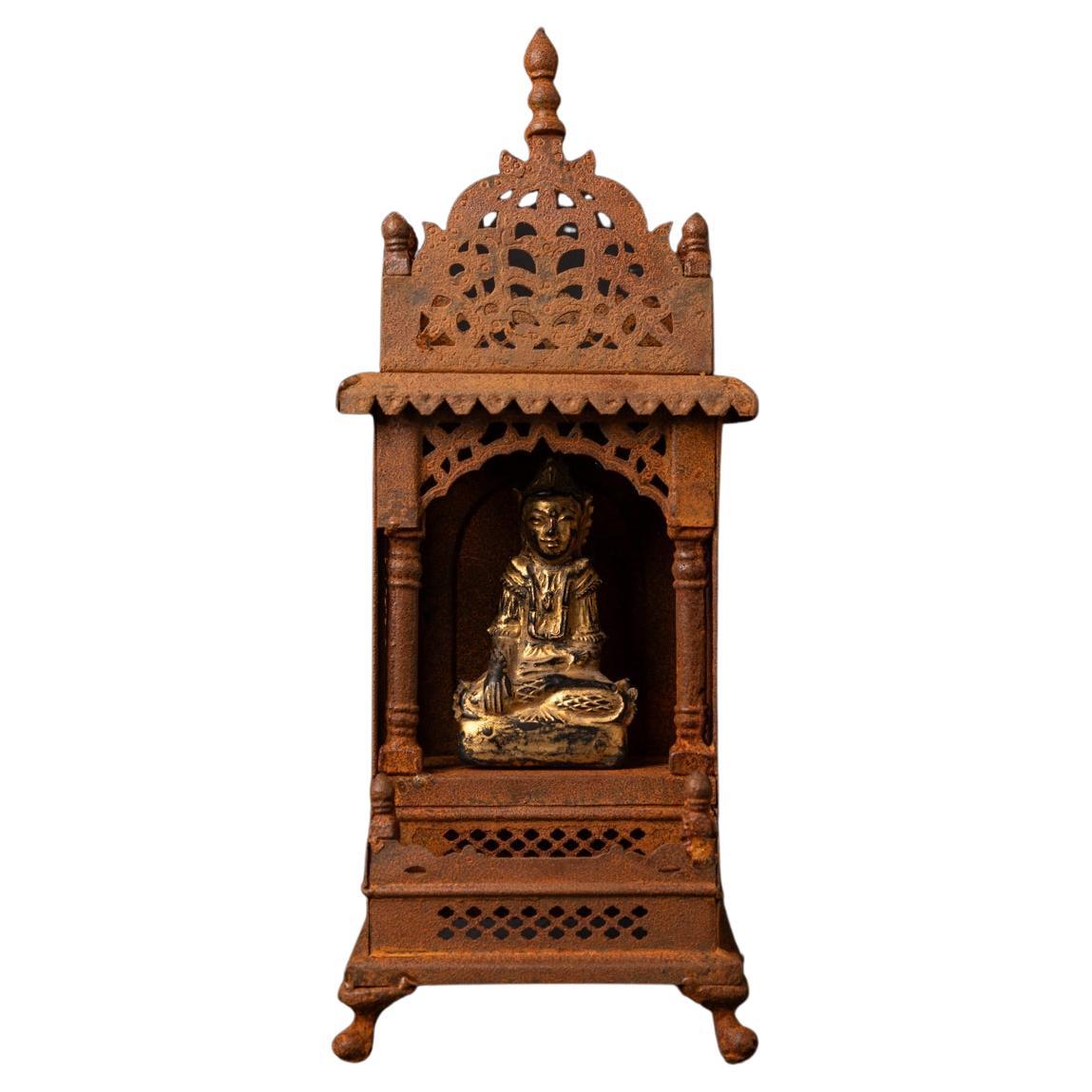 19th century Old metal temple with antique wooden Buddha statue