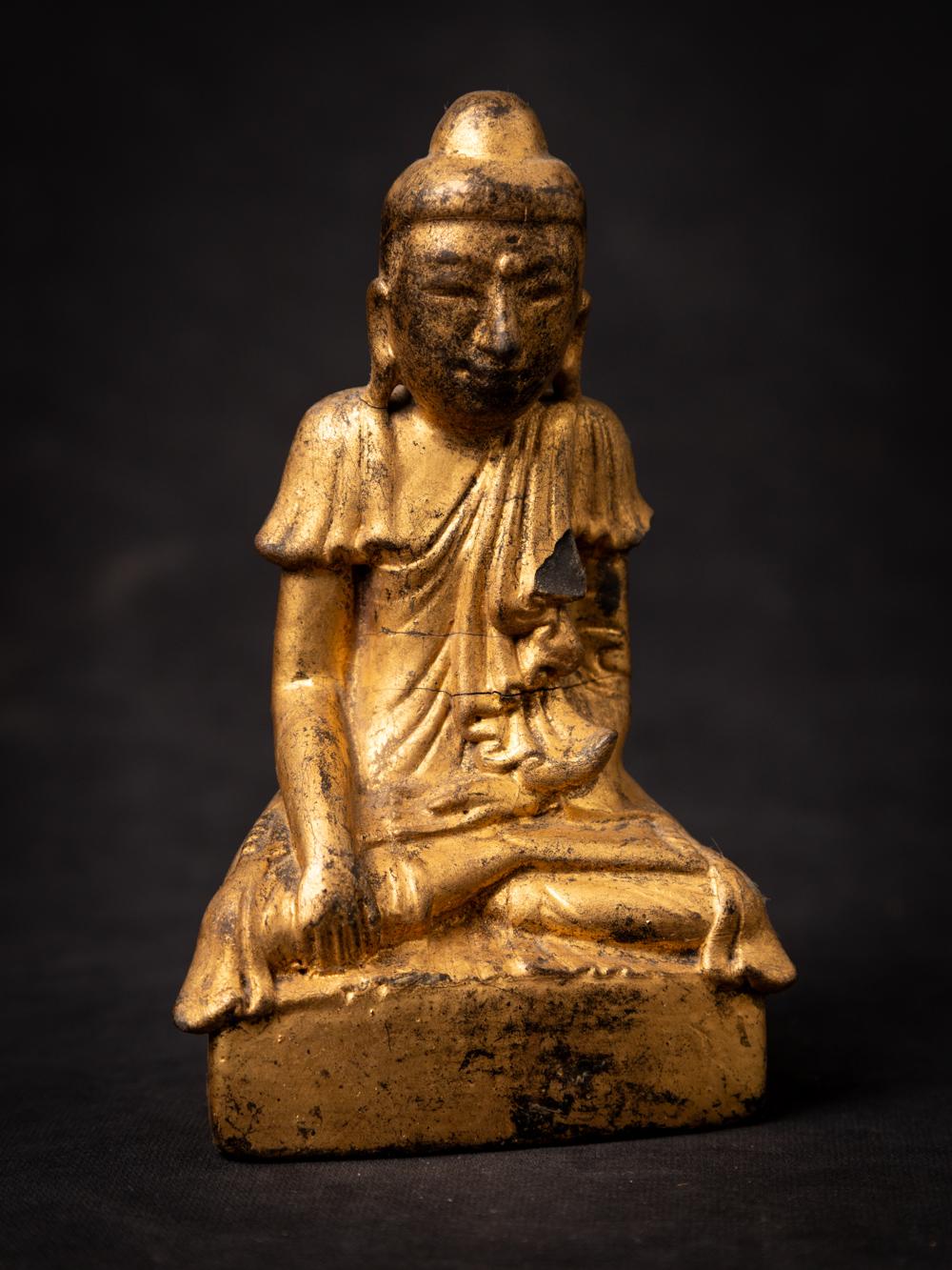 This Old wooden Burmese Shan Buddha statue is a remarkable piece of art and spirituality. Crafted from wood, it stands at a height of 14 cm, with dimensions of 8.5 cm in width and 4.4 cm in depth. The statue is adorned with the radiant beauty of