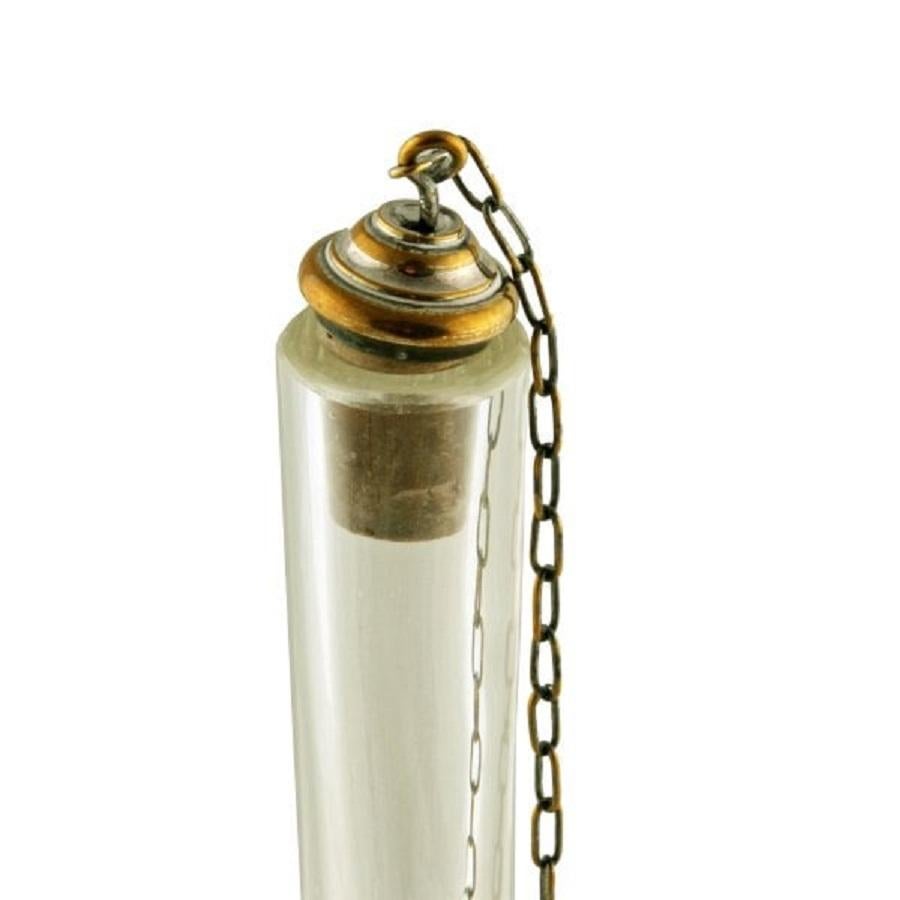 A late 19th to early 20th century tall oil decanter.

The decanter has a facet cut neck and lower body and a ground base.

The decanter has a silver plated handle that is held to the neck by a plated serpent.

The cork stopper has a plated top