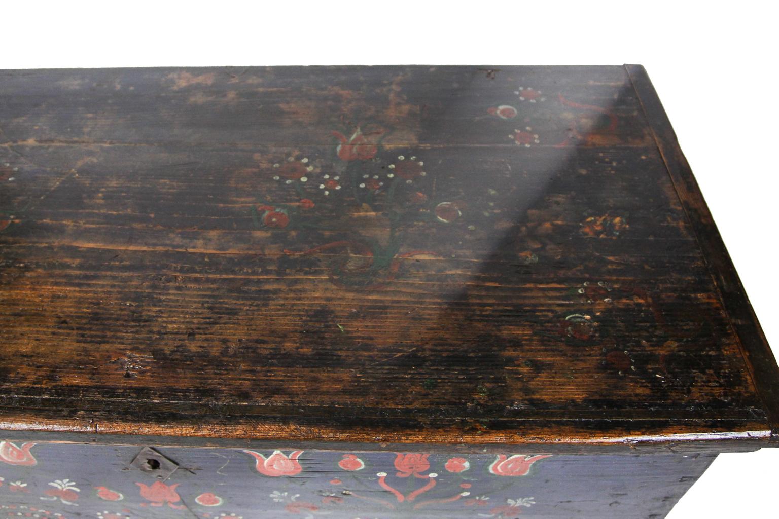 19th century one-drawer painted blanket chest, the dovetailed chest with stylized floral decoration on blue ground, original ring pulls, interior candle box, bun feet, dated 1892.