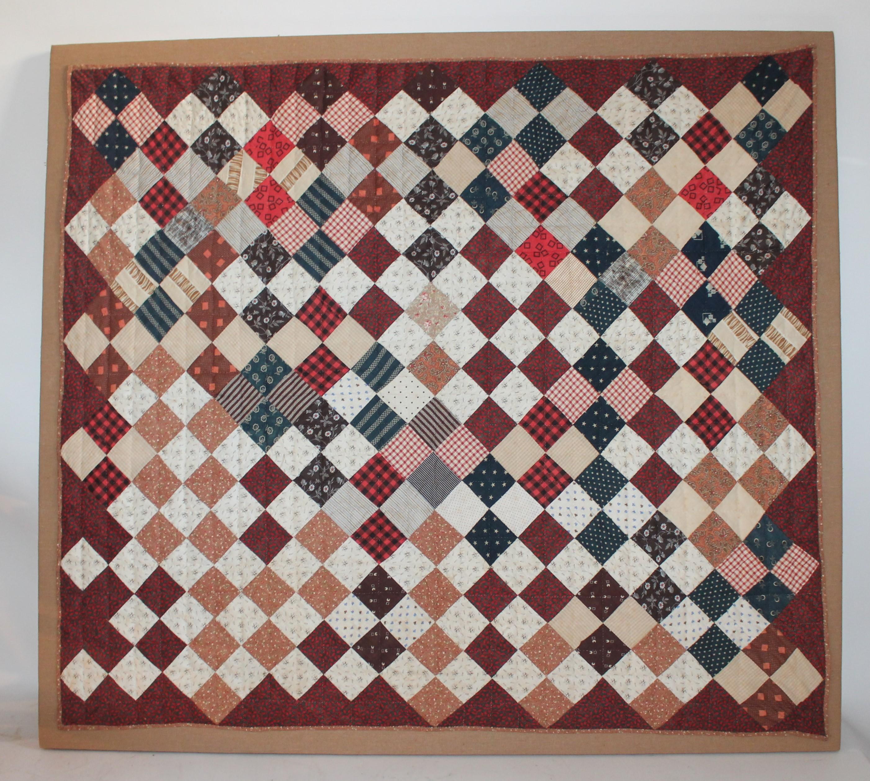 19th century one patch crib quilt hand-sewn on linen and on stretcher frame. This is in fine condition and is from Lancaster County, Pennsylvania.