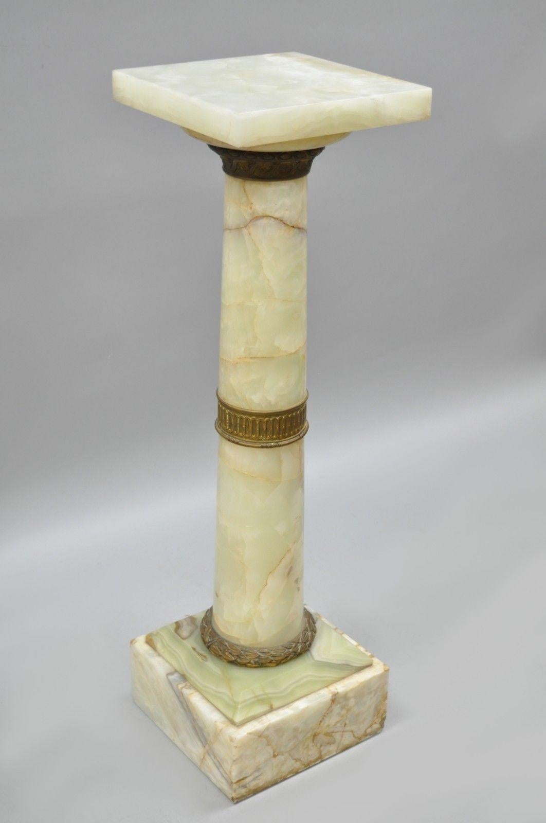 Antique 19th century bronze & onyx column revolving pedestal in the French Empire style. Item features revolving top, bronze ormolu, beautiful green and beige onyx stone and timeless Classical form, circa 19th century. Measurements: 42