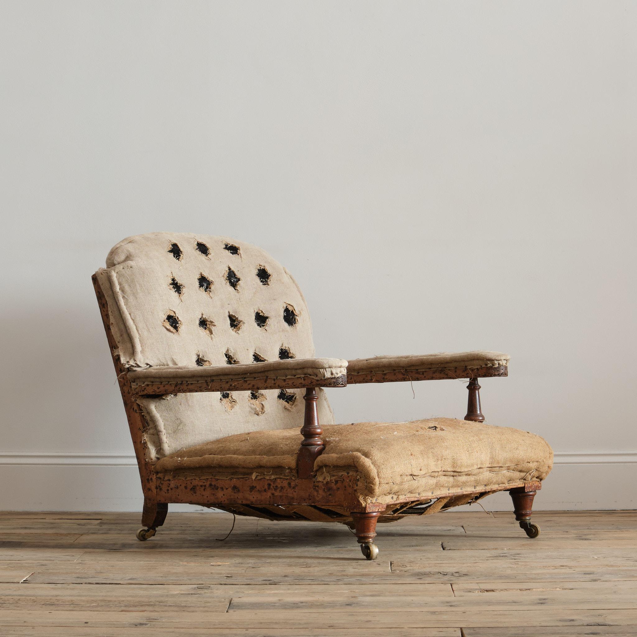 A good quality low deep seated mid 19th century open armchair by Robertson & Coleman of Norwich. Raised on turned Oak front legs and arm supports. 1 back leg bearing the makers plaque. c1885

Structurally in good solid order and requiring