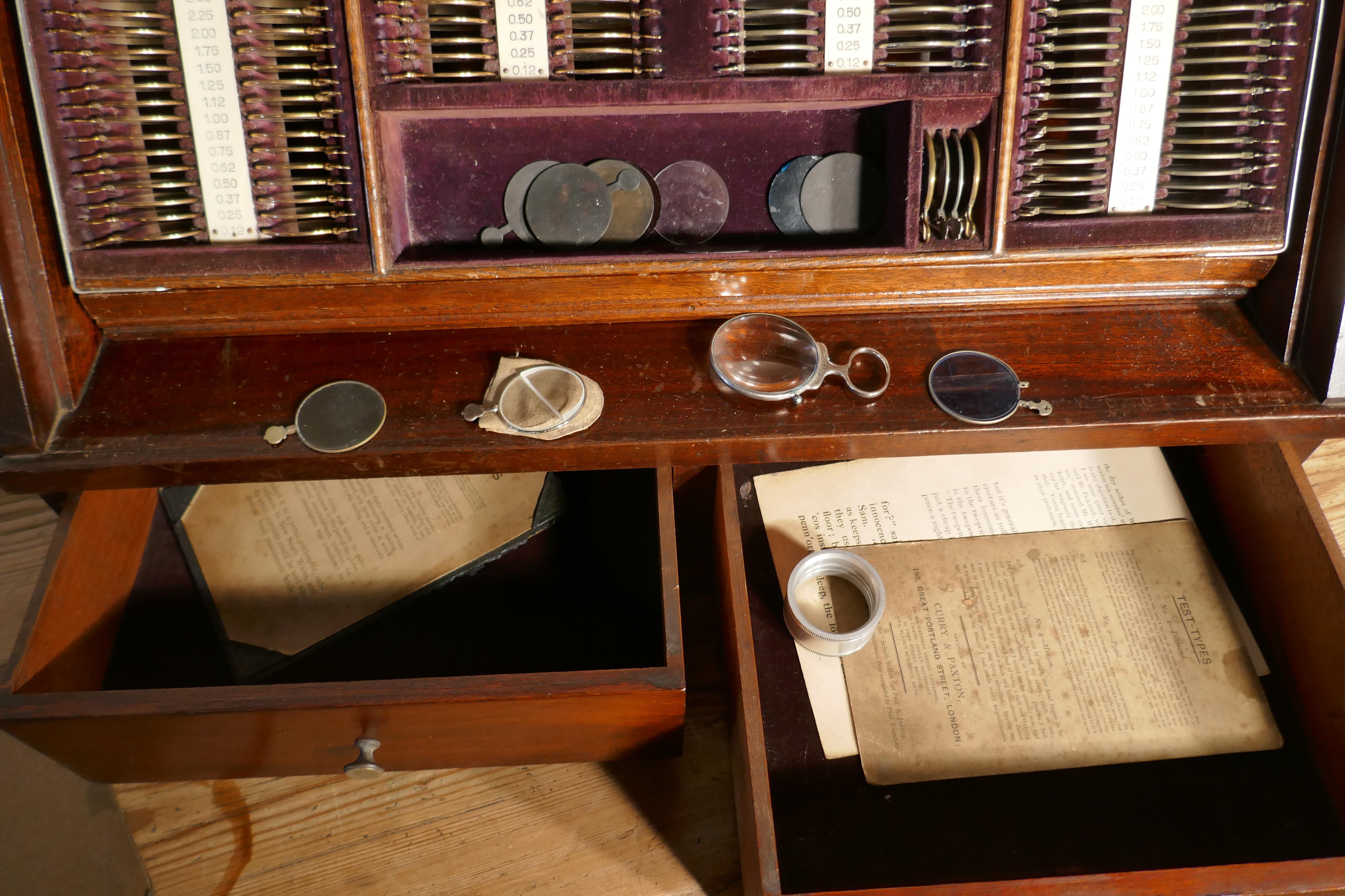 19th Century Optician or Optometrist Test Glasses Lens Kit in Cabinet 

This beautiful Mahogany cabinet was used by a traveling optometrists to treat patients in their homes.  
The glass front lifts up and slides down inside the cabinet on a