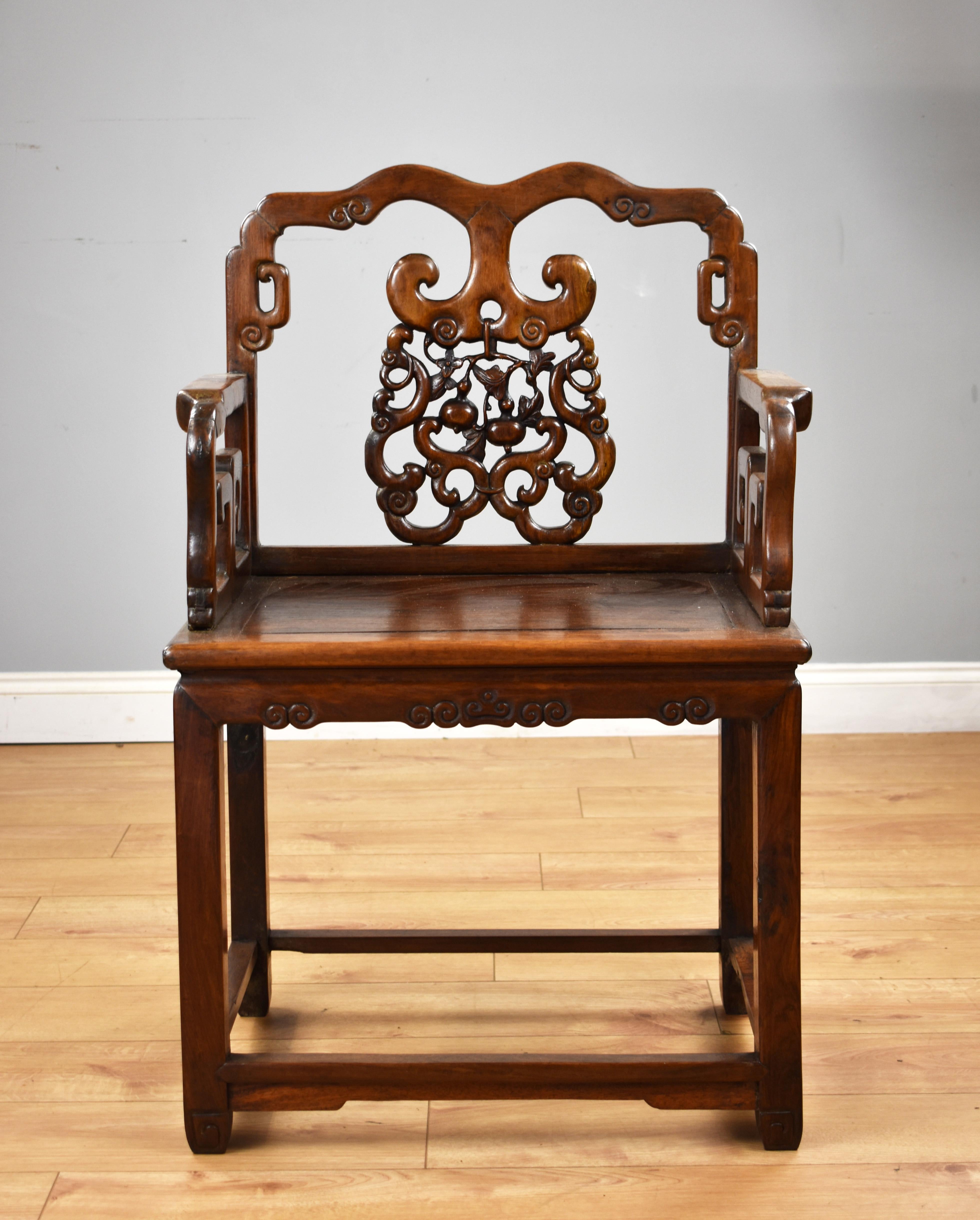 For sale is a good quality oriental armchair, having an ornately carved back, square seat above a square stretcher base. The chair remains in very good condition being structurally sound and having a nice patina. 

Measures: Width 25.5