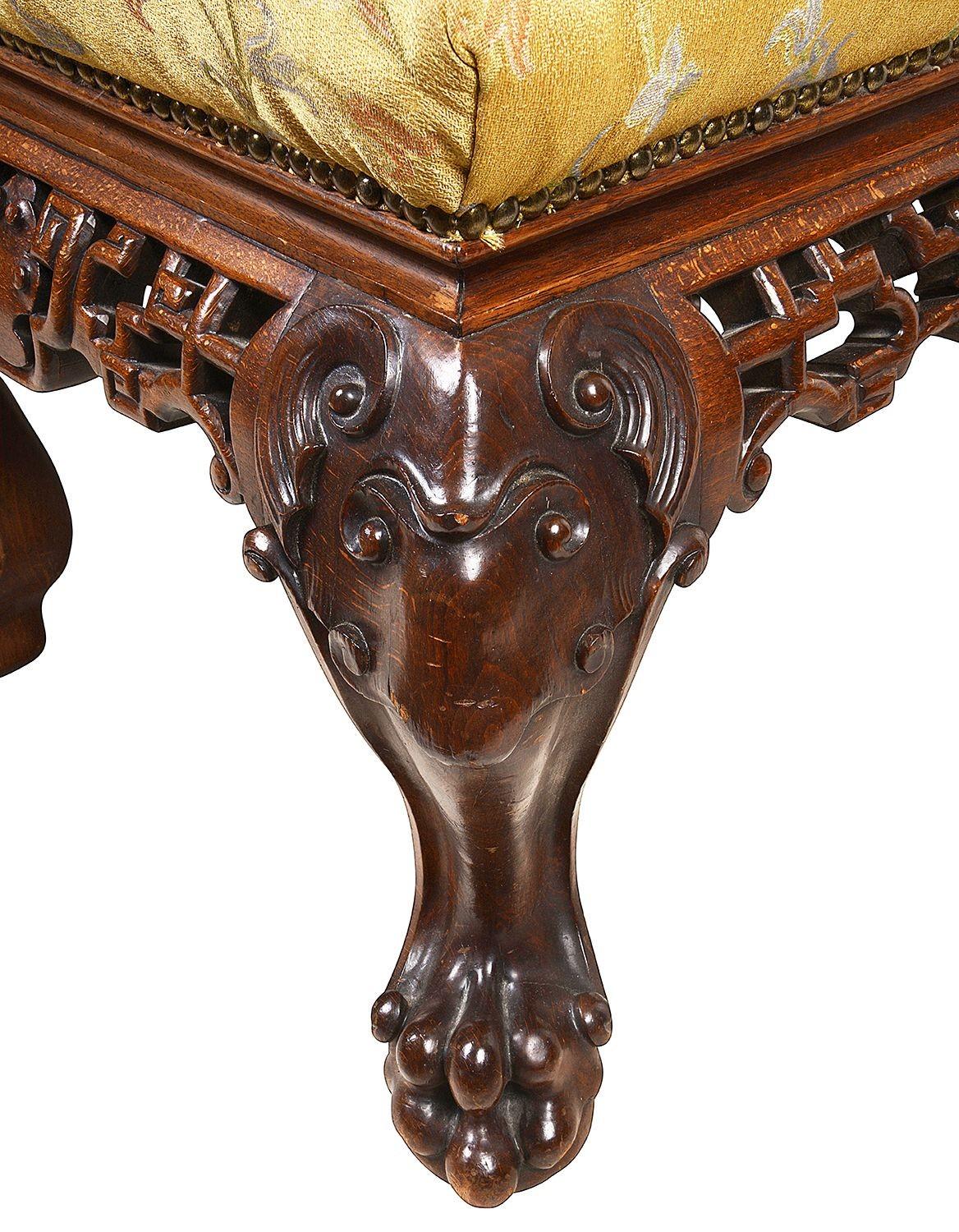Ein wunderbar stilvoller Hocker im orientalischen Stil des 19. Jahrhunderts, mit durchbrochenen Laubsägearbeiten auf dem Fries, Stoff über gepolstertem Sitz, auf klassisch geschnitzten Cabriole-Beinen mit mythischen Masken, die in Krallenfüßen