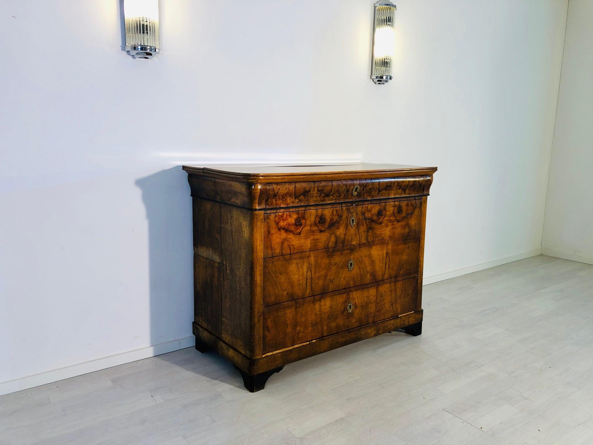 Noble Biedermeier commode or chest of drawers with three large and one small drawer for storage considerations. Features an elegantly made and carefully selected walnut grain / veneer picture which extends over all three drawers. All drawers come