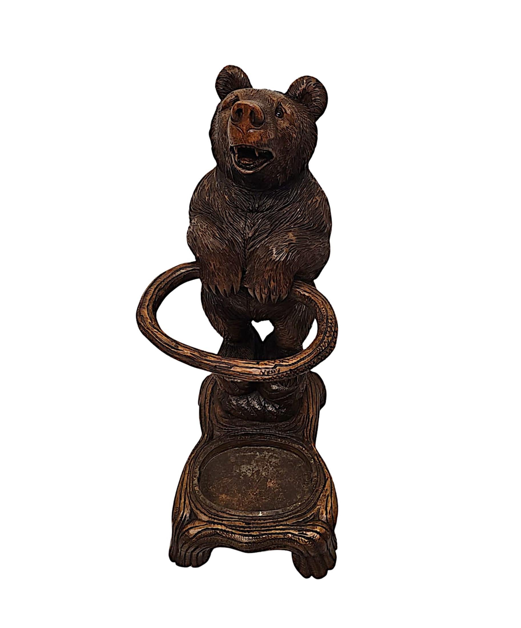 A very rare 19th Century original Black Forest bear stick or umbrella stand.  This finely hand carved animalier sculpture executed with incredible workmanship and attention to detail depicts a bear in upright pose holding an oval shaped tree branch