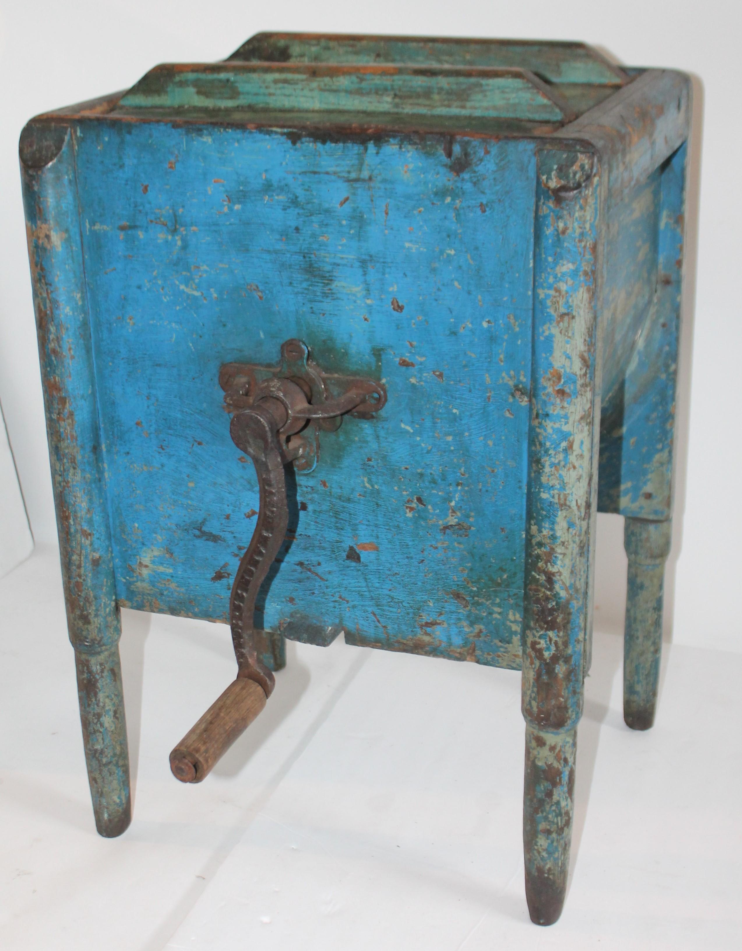 This 19th century original blue painted pencil post legs stand churn table. Great as a table by itself without side crank for churning butter. The lid is removable as well. Iron crank is on one side of the churn. This blue is the magical color and