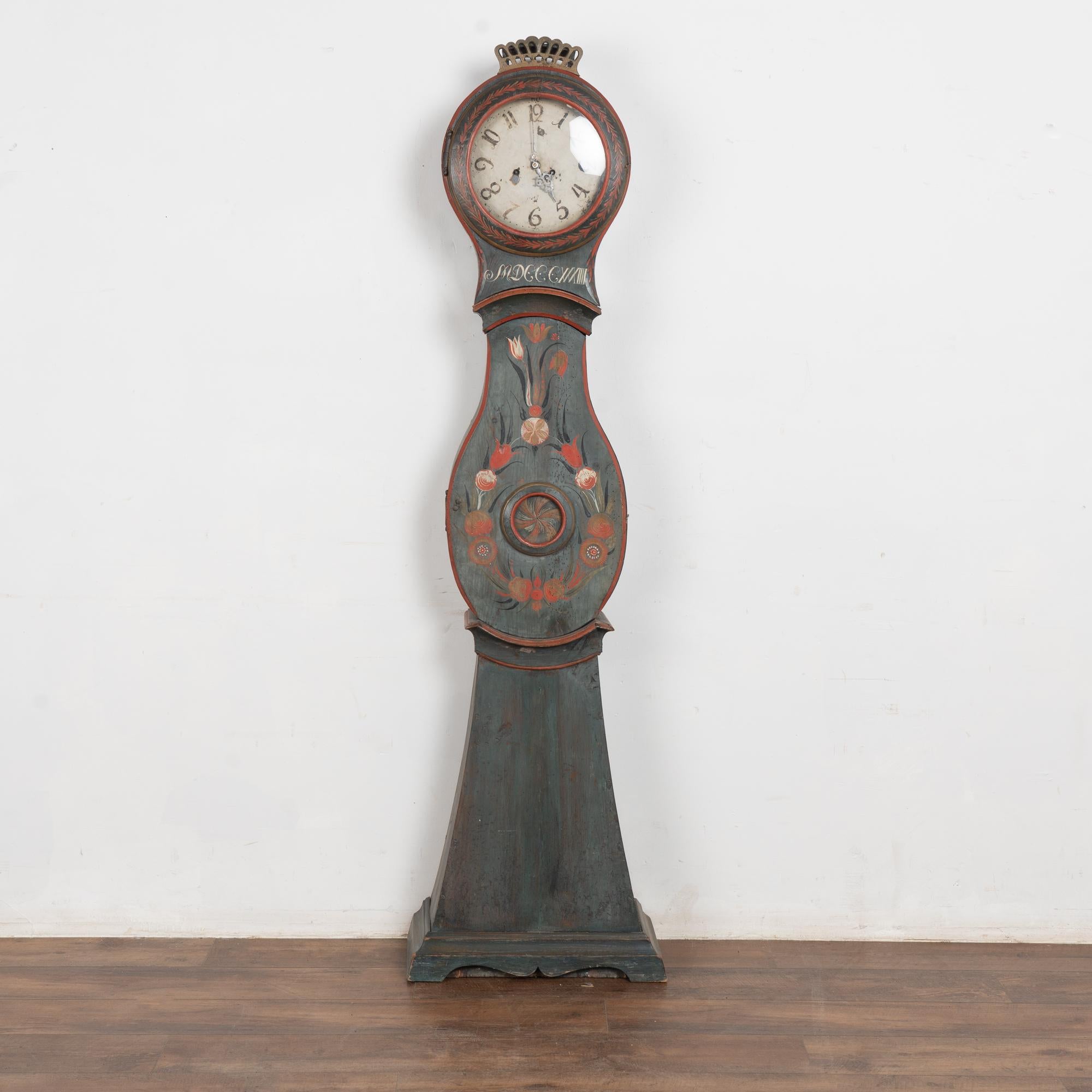 Antique Swedish Mora Grandfather clock with original blue painted finish. The monogram indicates this clock was likely a wedding or dowry present. 
Pine longcase with original folk art paint with traditional flower motif. The original clock required