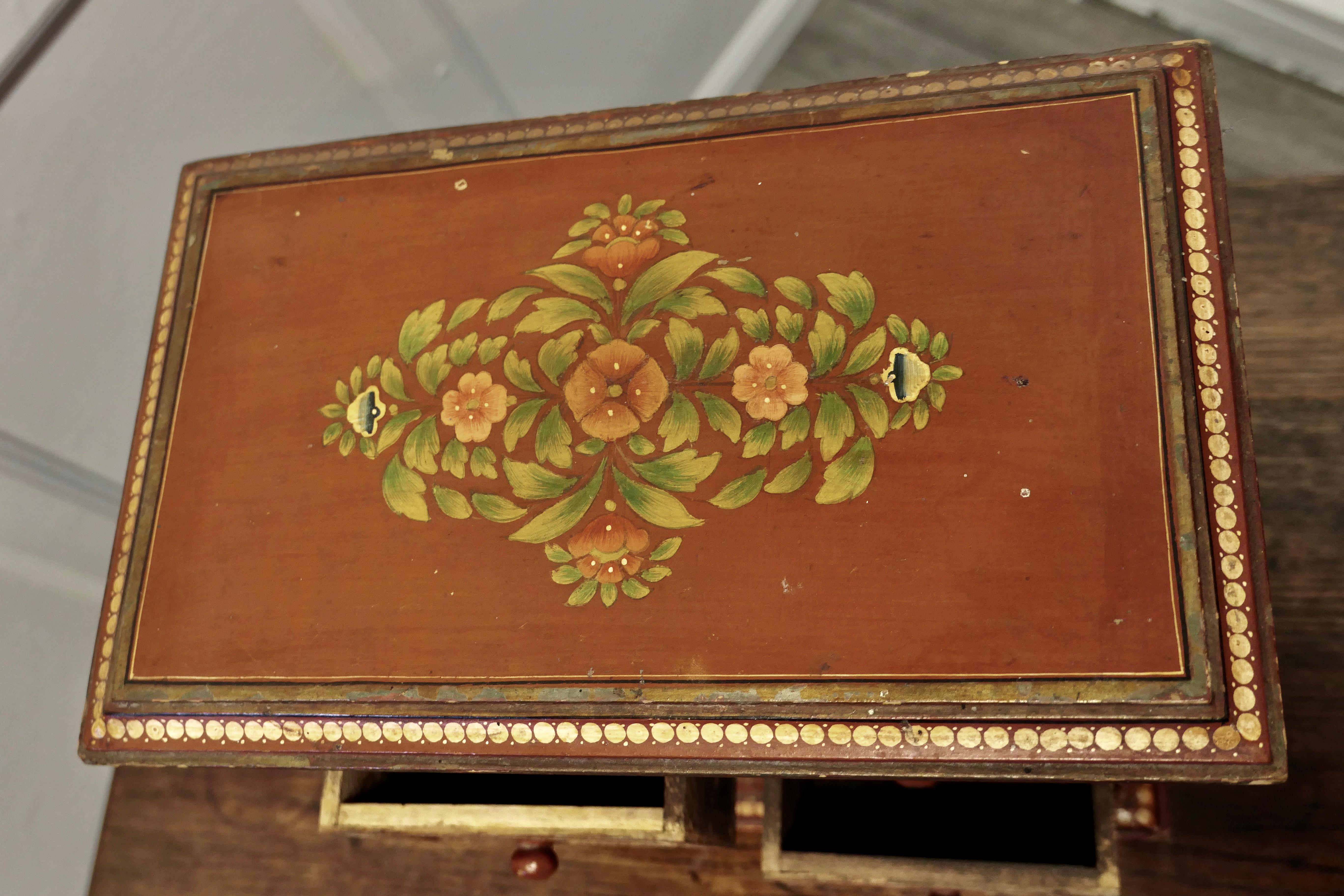 19th Century original Folk Art painted chest of drawers.

A Very attractive painted pine chest of drawers, it is decorated with flowers on the top and sides, the drawer fronts and the mouldings are also decorated. 
This is a very attractive