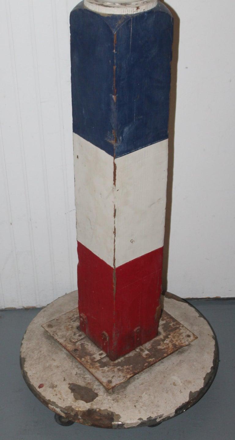 This funky barber pole was found in the mid west and retains its original painted surface. Painted Steve's name on the pole and iron base and wheels. Steve's I’m sure was painted years later but has age to it as well. The base is very cool and has