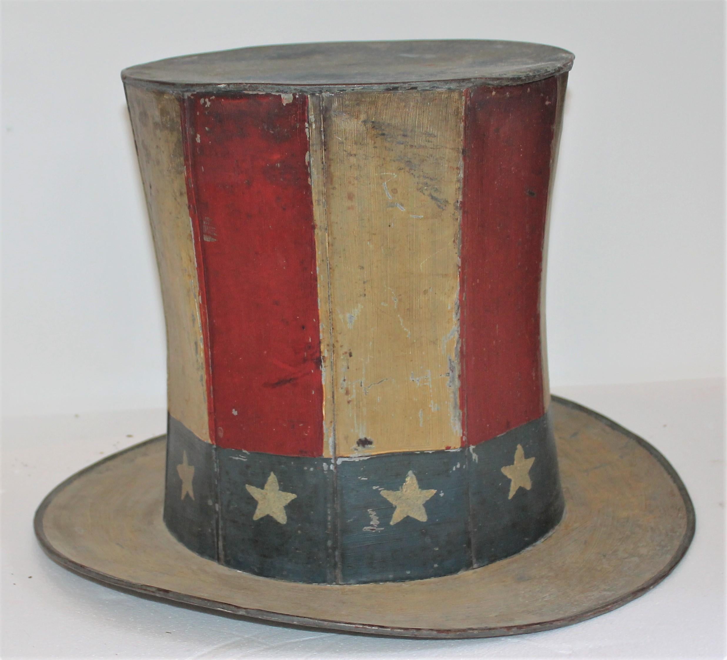 This original painted tin trade sign of a patriotic motif. Looks like a Uncle Sam's top hat. This hand made and painted tin trade sign is signed by the maker and dated 1881.

Interior diameter measures - 10inches.