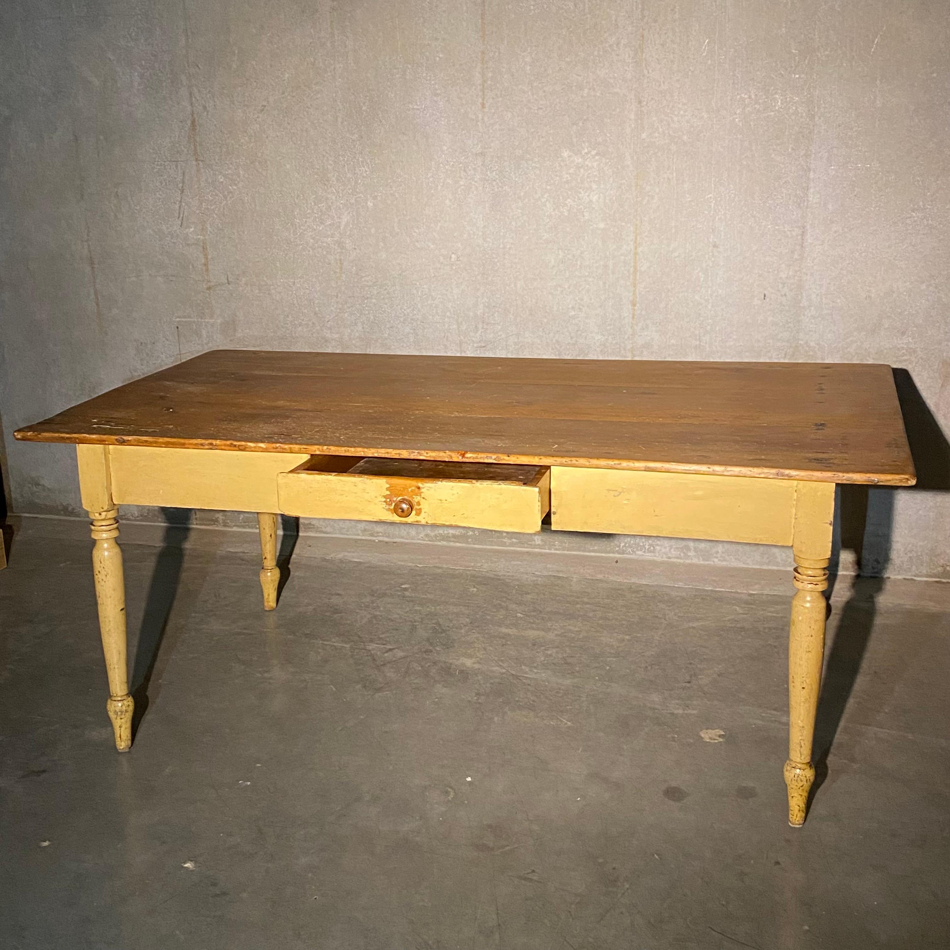 An exceptional farm table with nice three board pine top, set of a turned leg base in old age cracked polychrome painted finish. This table is as found, with a working drawer extra wide top and beautiful old painted base.

Found in Central Quebec