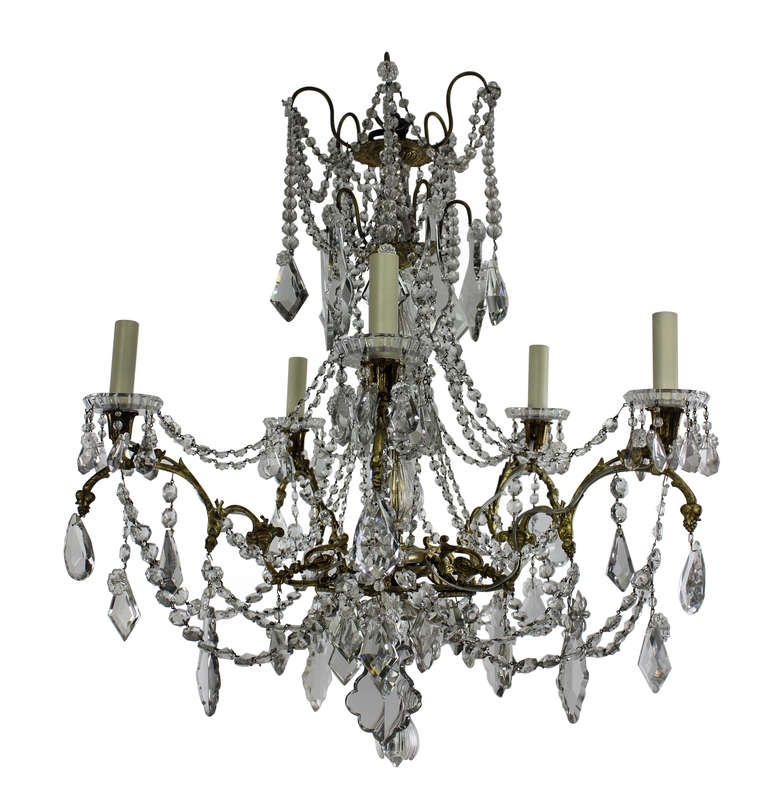 A French chandelier of five branches in ormolu-and hung with cut-glass by Baccarat of Paris, signed.