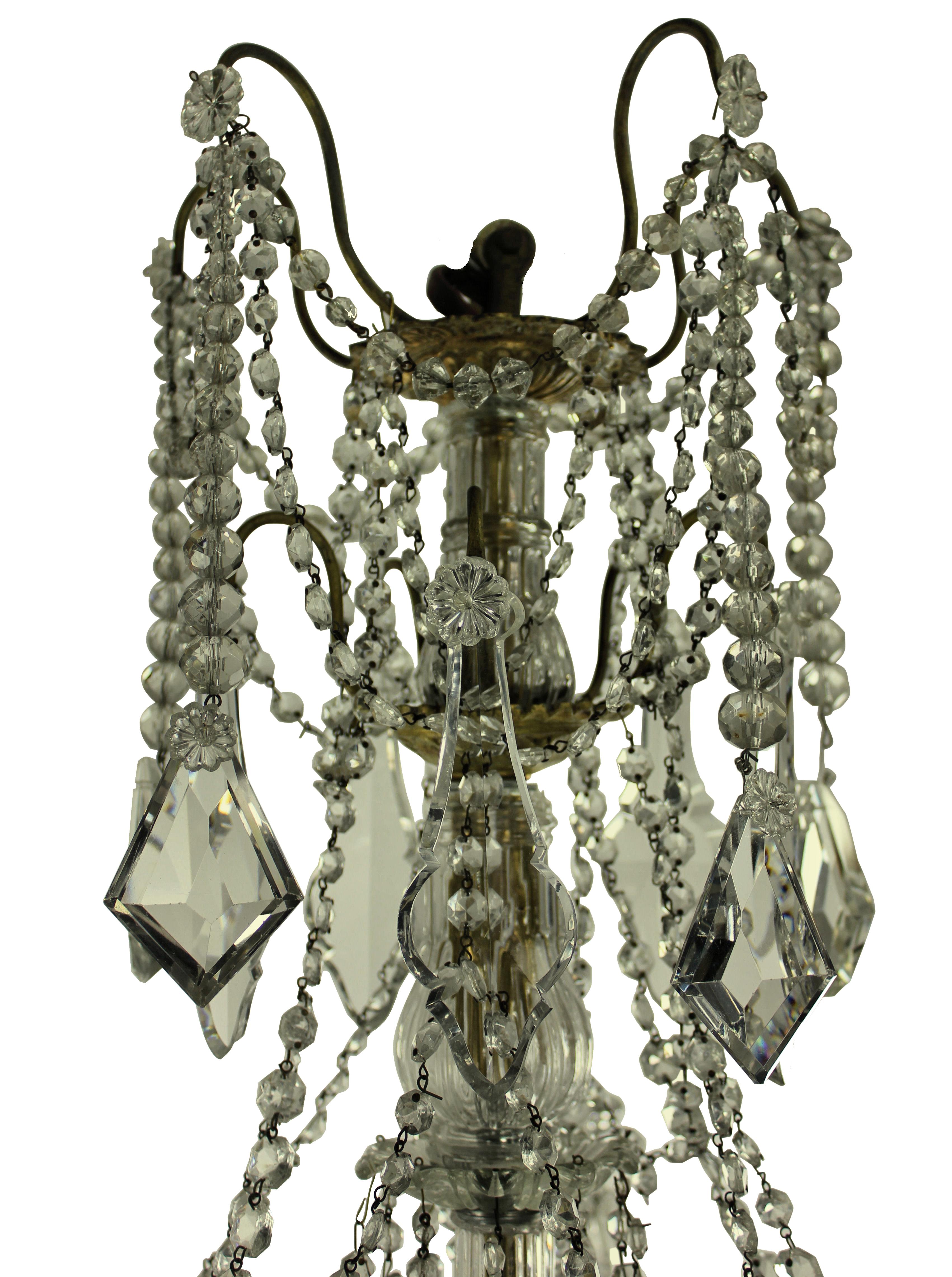 A French chandelier of five branches in ormolu and hung with cut-glass by Baccarat of Paris, signed.