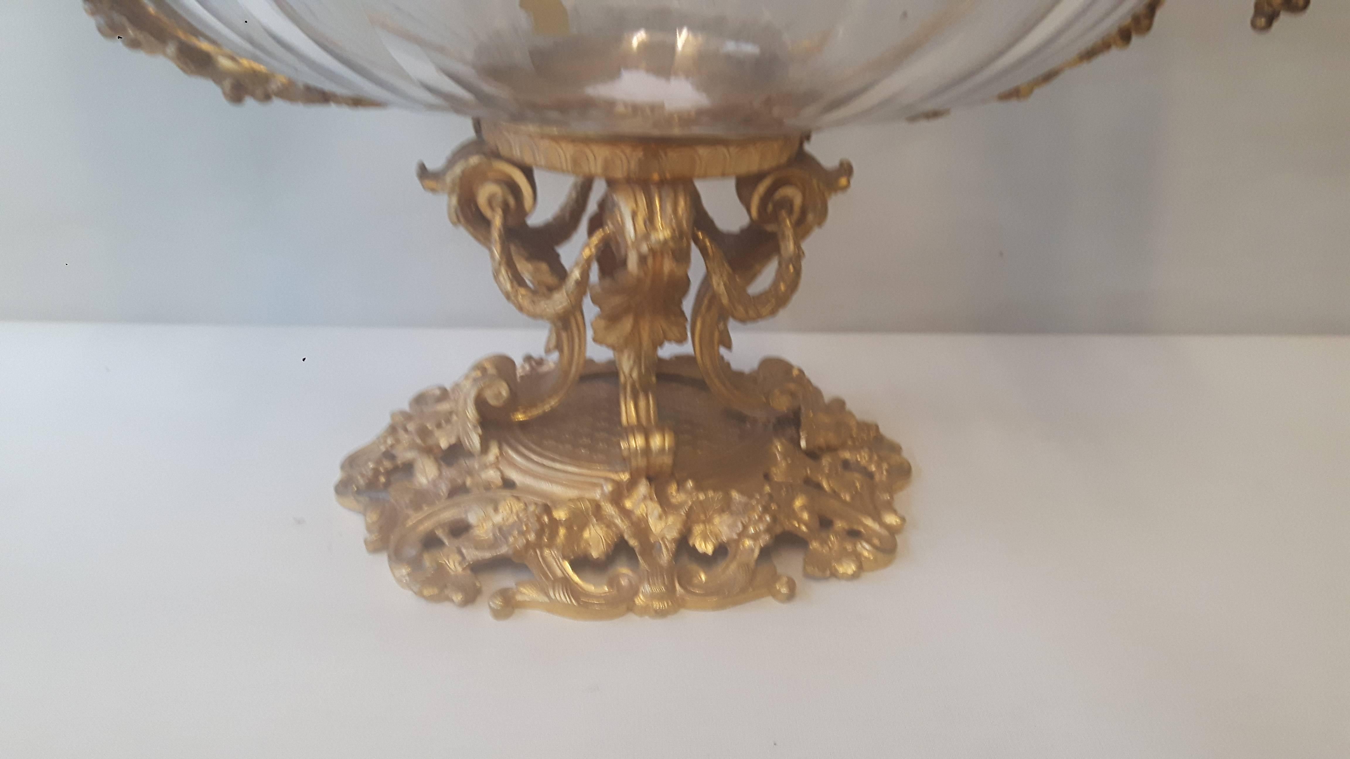 A wonderful French cut-glass (Probably Baccarat cut) and ormolu grape dish, circa 1870. The body is encased by a gilt ormolu frame, with moulded vine leaves and acorns, the handles entwined with vines around a Bacchanalian head, the whole resting on