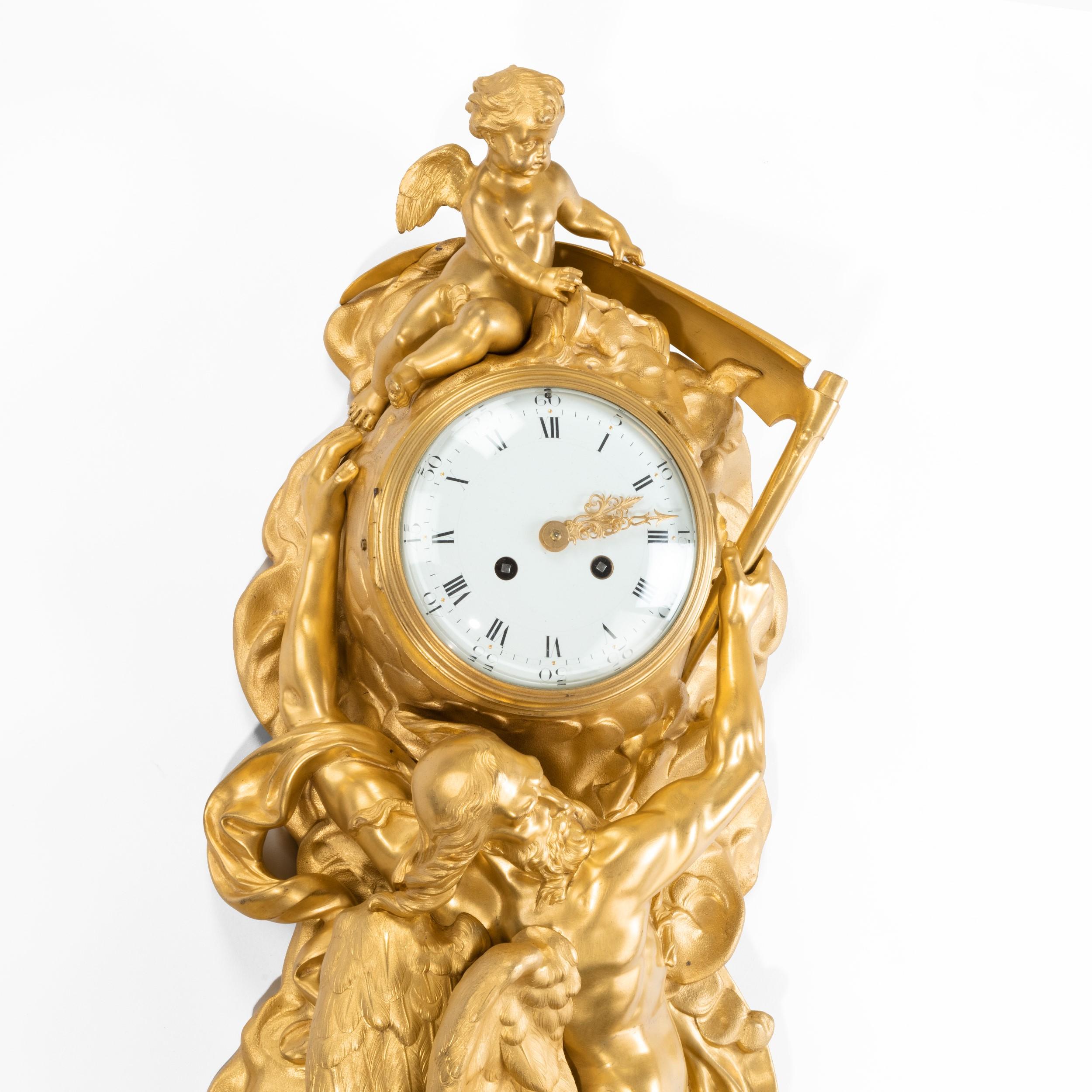 An ormolu cased Cartel clock by Vincenti & Cie

Constructed in gilt bronze, depicting a well modelled figure of Father Time, carrying his scythe, with a winged cherub surmount, houses a circular enamel faced clock, the gilt hands delineating the