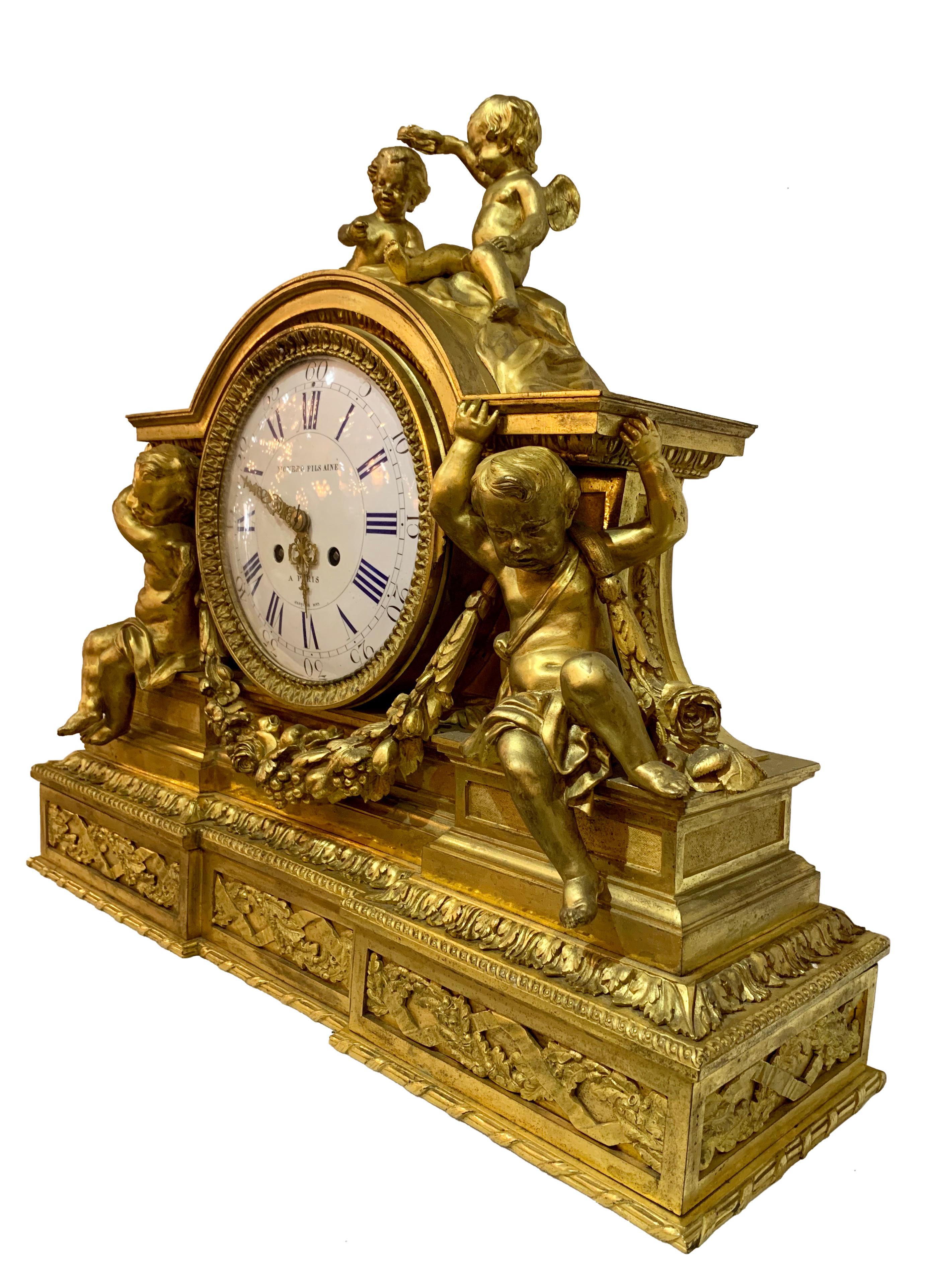 Imposing 19th century French Napoleon III Gilt Bronze striking Mantel clock. Flanked by two sitting cherubs and another two cherubs on top, this is another example of a fine French mantel clock.

This particular clock was crafted by famed French