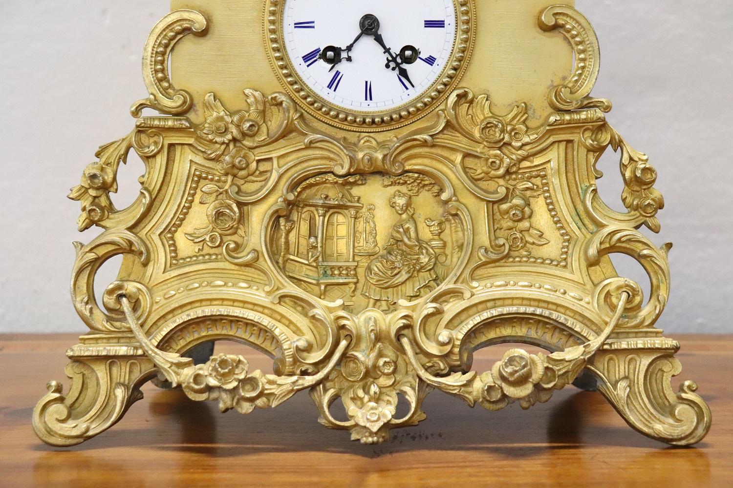 Rare antique 19th century table clock in ormolu gilt bronze. Characterized by a refined decoration chiseled in bronze, in the upper part a sweet girl leaning against a frose tree waiting for her lover. The mechanism is present but currently not