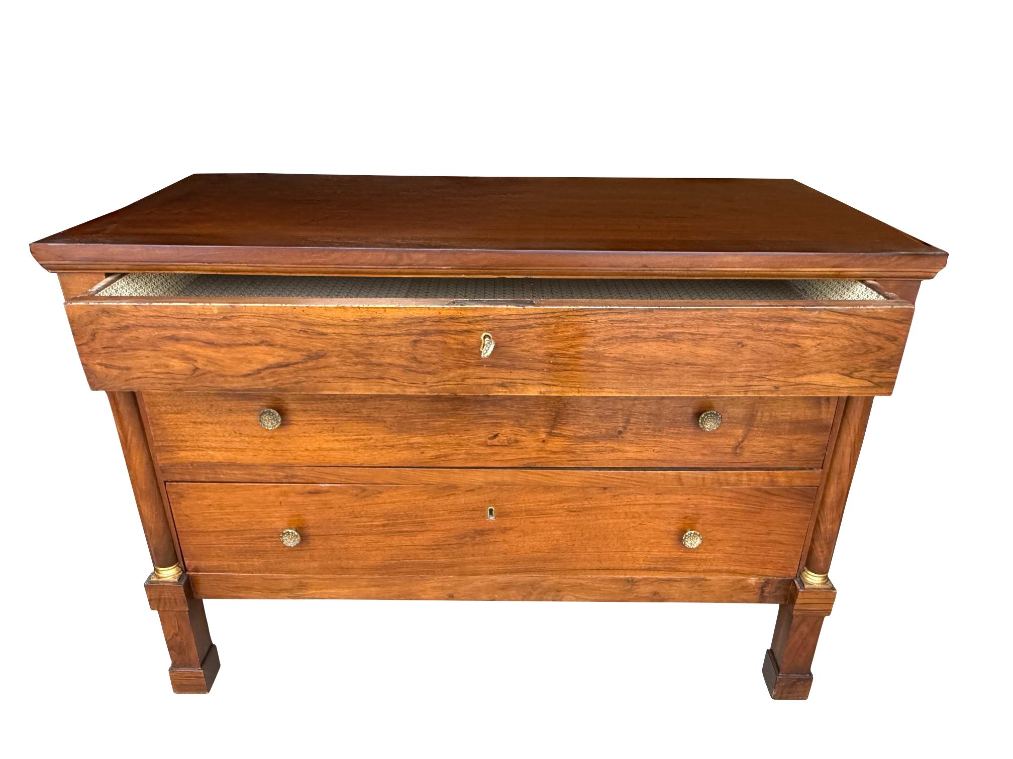 19th century Italian walnut three drawer commode with ormolu trim.
Classic design with decorative columns on both front corners.
Newly restored. 
