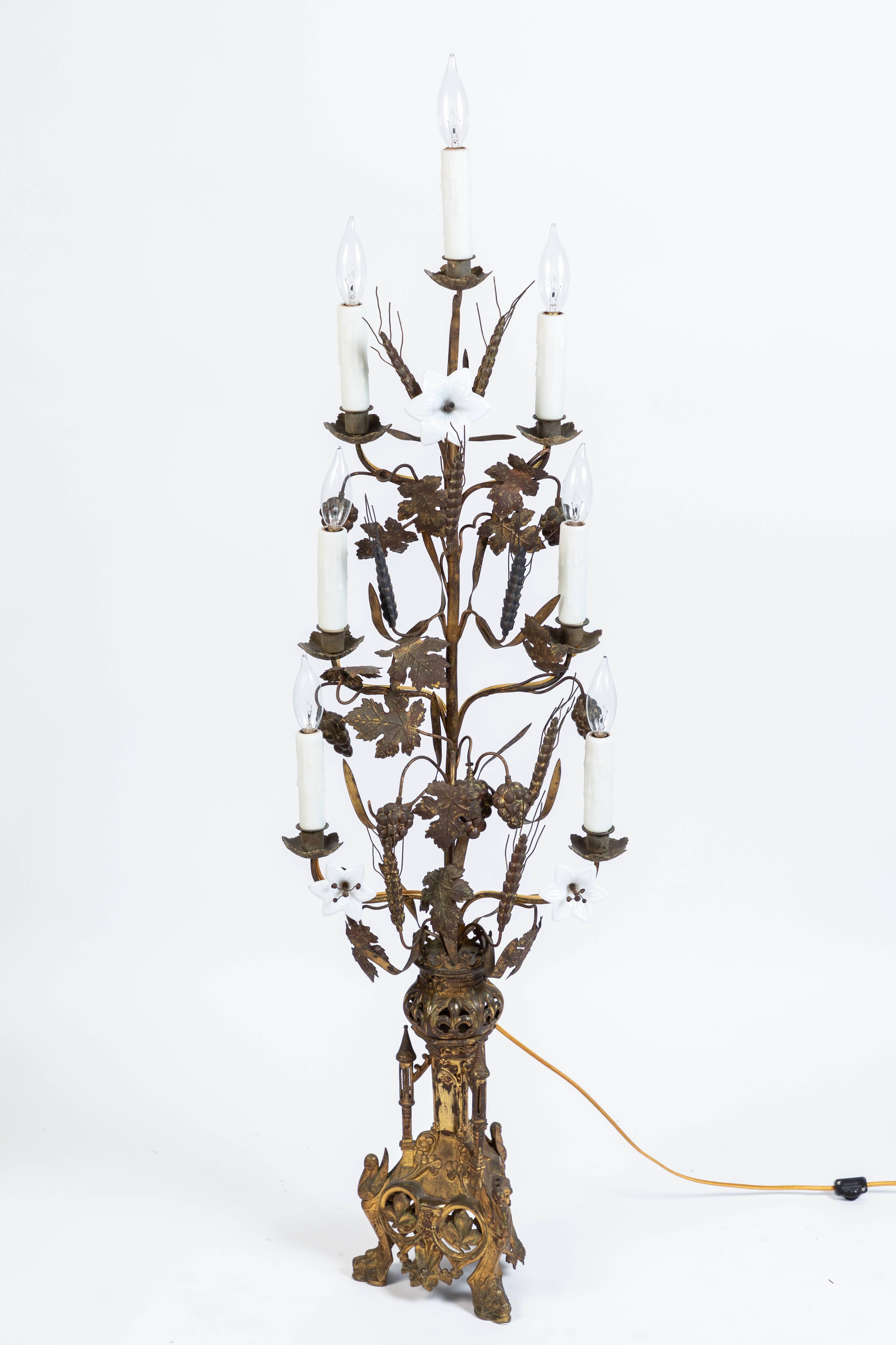 19th century impressive ornate antique French gold gilt altar lamp (Seven branch). Features harvest motifs (Wheat and grape bunches), fleur-de-lis, crown, turrets, swans, three white opaline glass lily flower accents and gargoyle heads at the base.