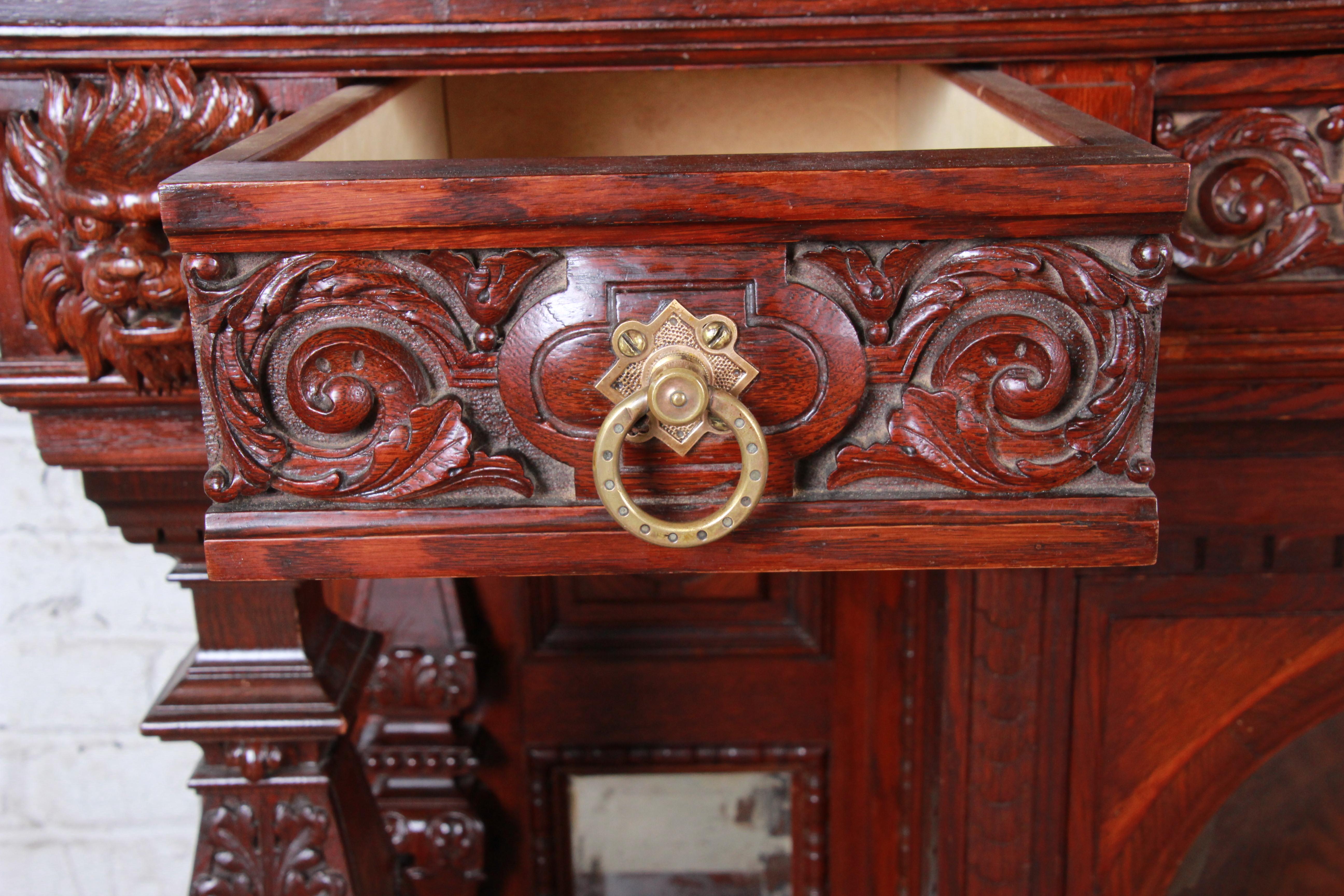 19th Century Ornate French Oak Sideboard Hutch or Bar Cabinet with Carved Faces In Good Condition In South Bend, IN