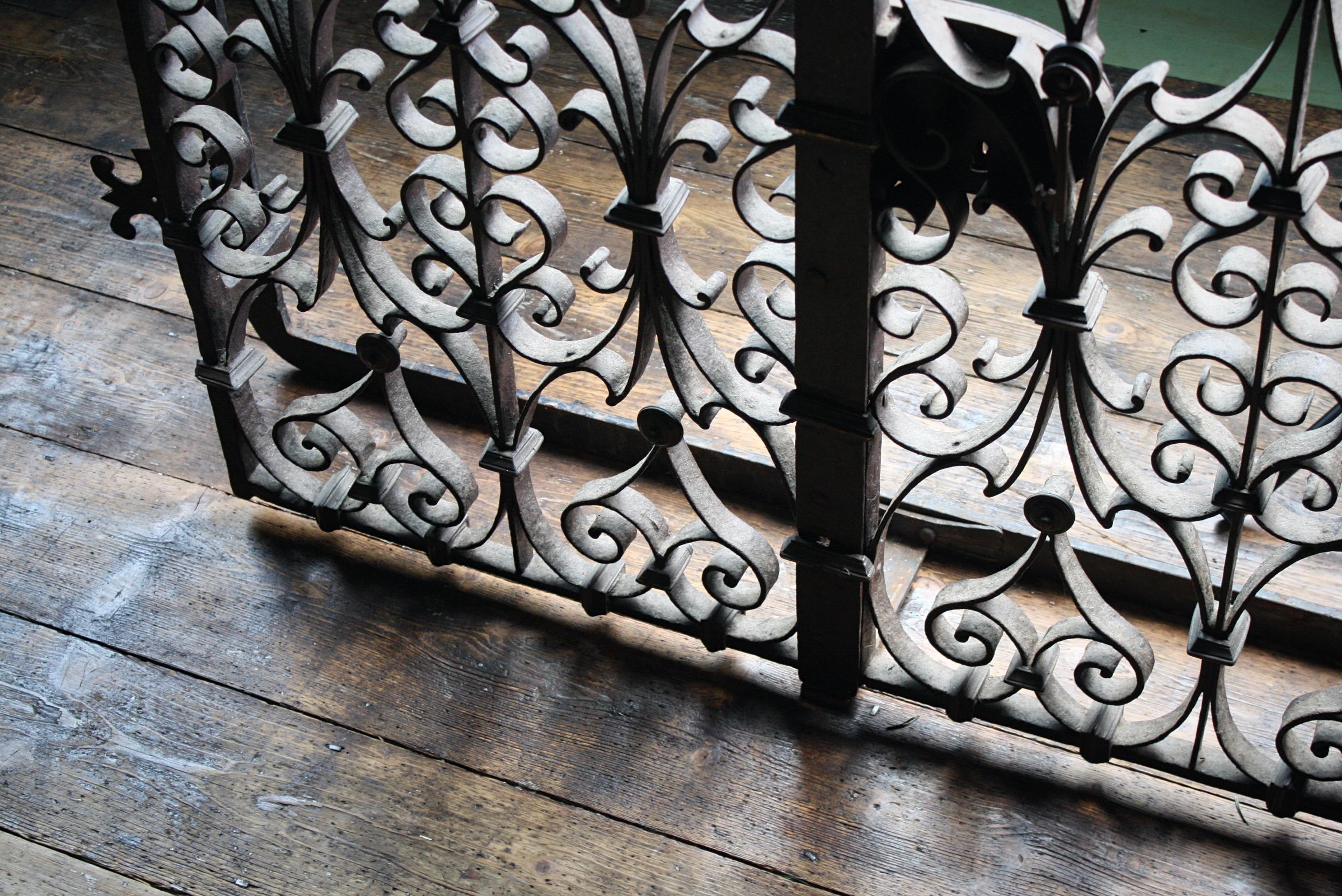 A highly decorative window grille, constructed with hand forged wrought iron and bronze decorative elements. The grille has its original key and lock, age related wear yet complete and very much fit for purpose. The grille opens as you would expect