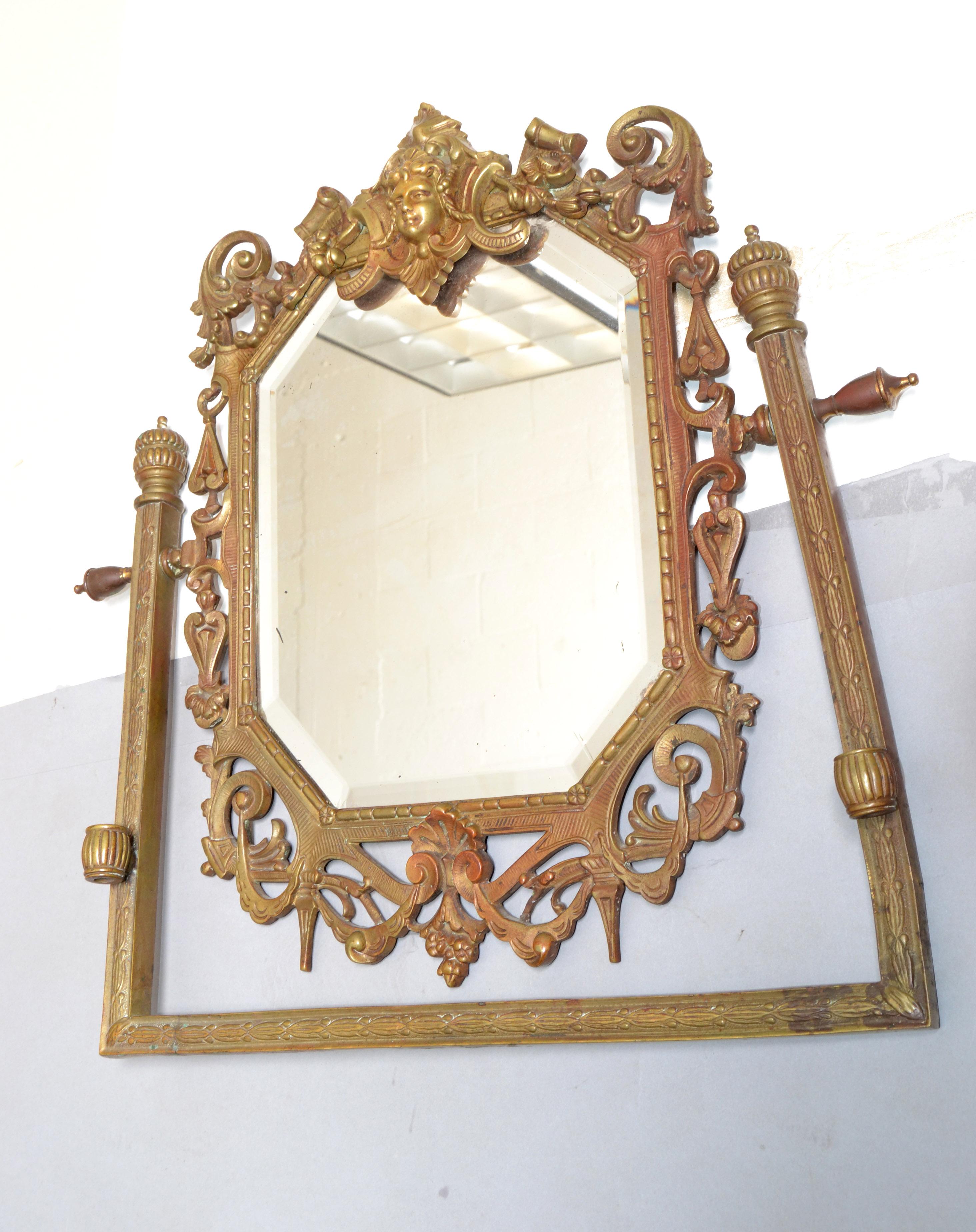 French Baroque Bronze rectangle wall mirror ornate and decorated with Angel, acanthus leaf and scalloped shell design. 
The original octagonal Mirror Glass is beveled and shows some age-related foxing.
We believe it is dated to the late 19th