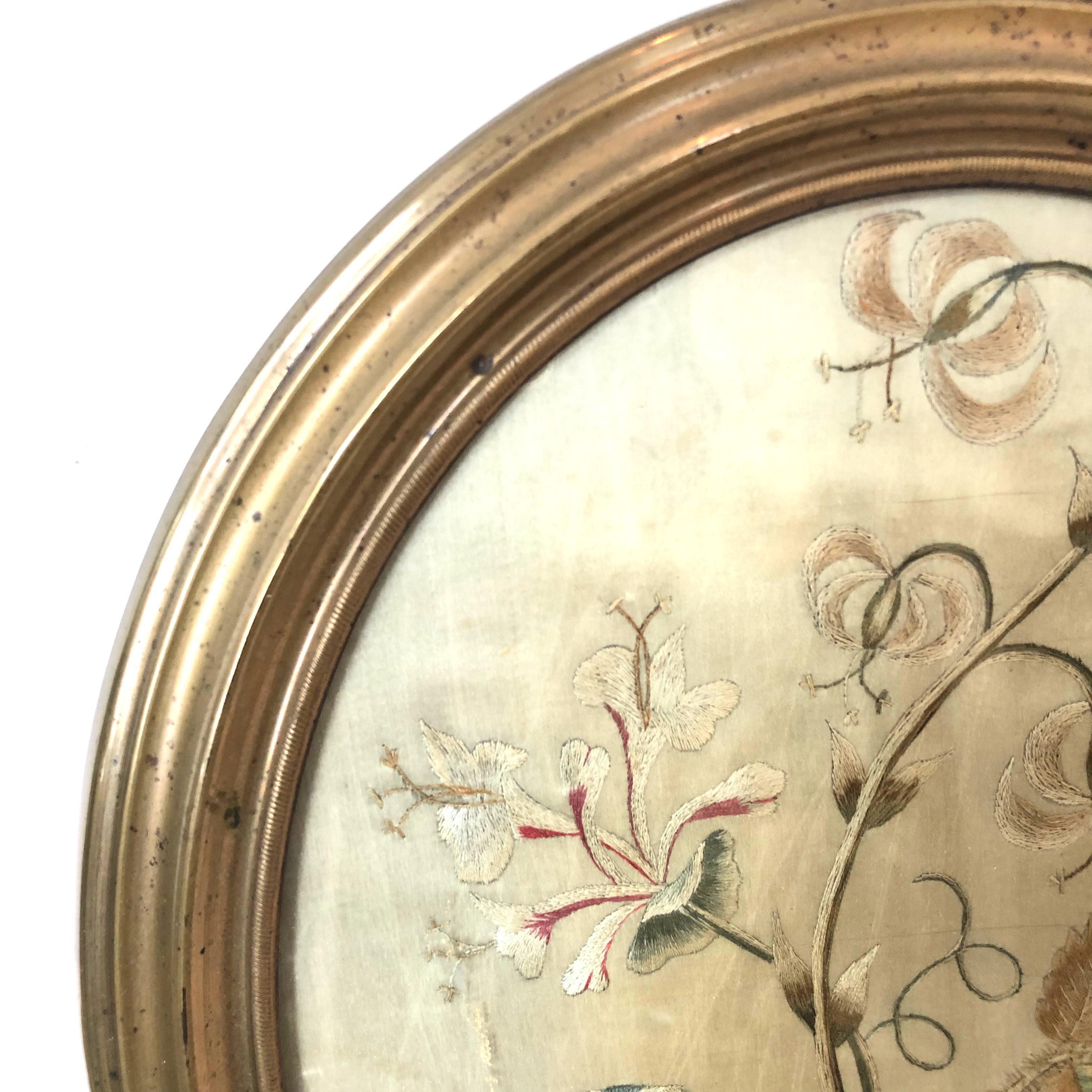 19th century oval floral silk embroidery in metal frame.