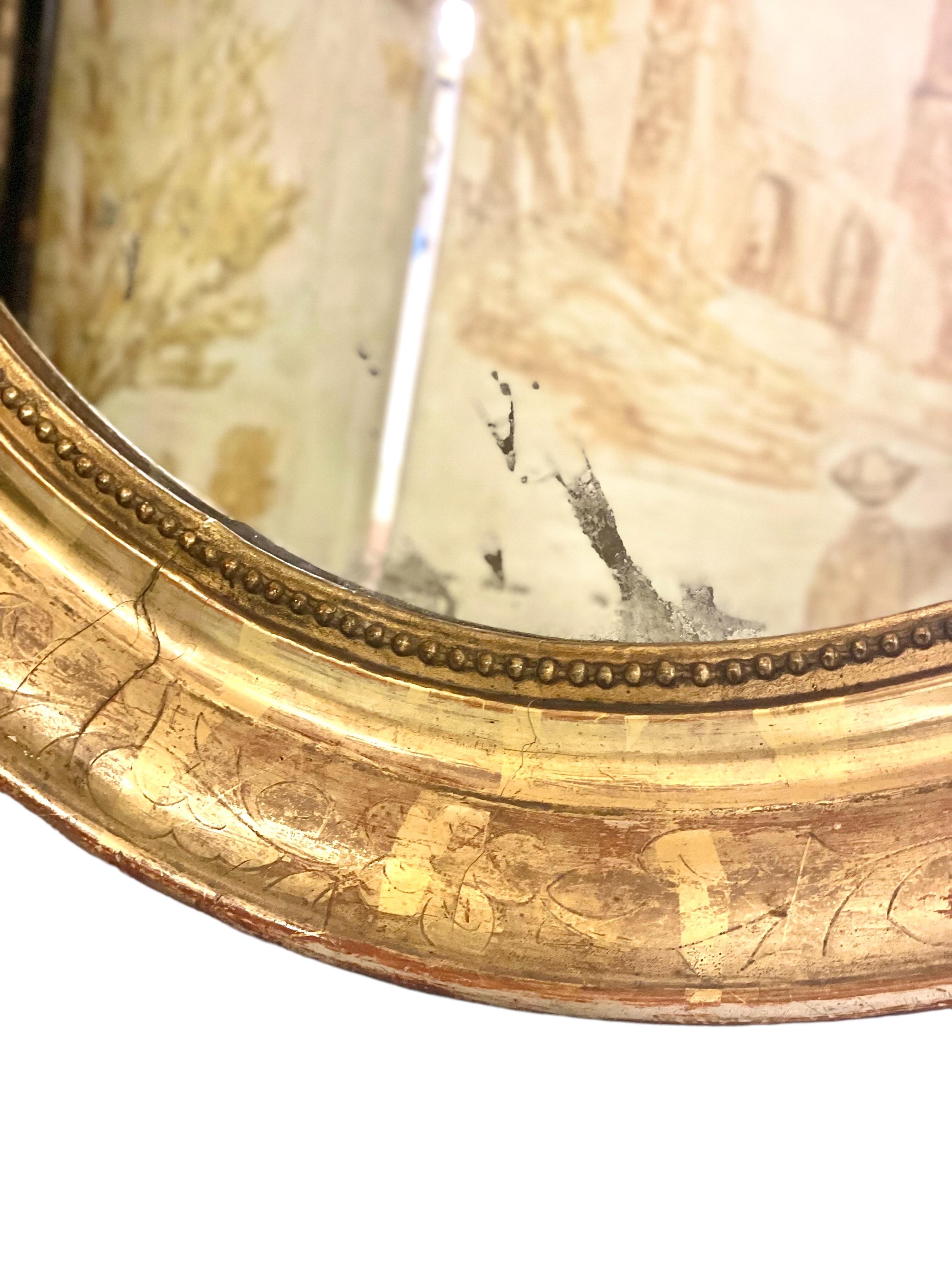 Français Miroir mural ovale doré du 19e siècle en vente