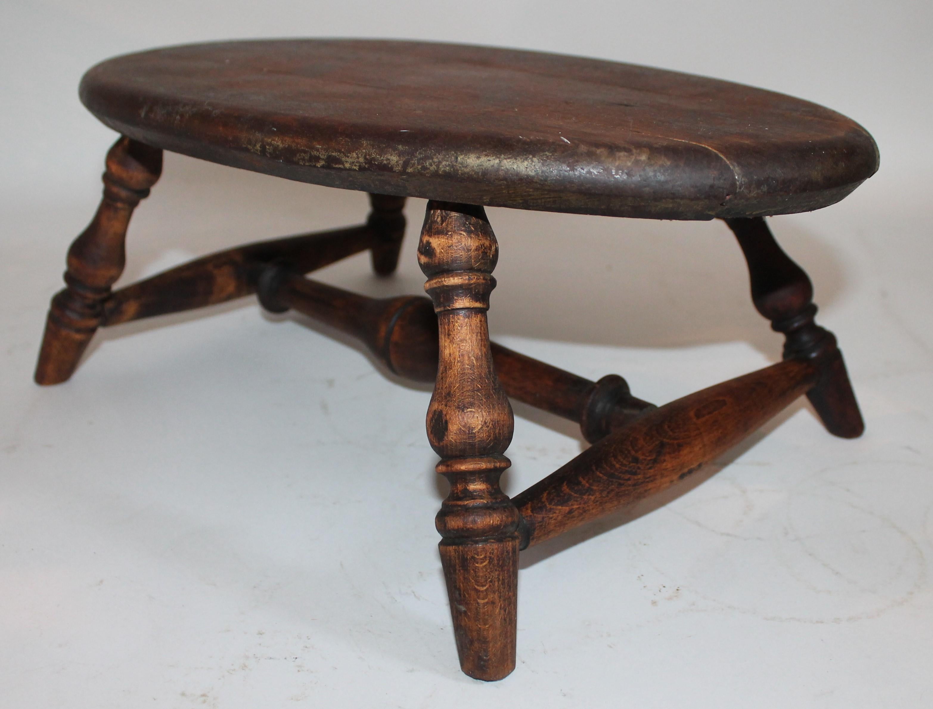 This fine early hand-carved foot stool was found in the state of Maine. It is in good condition with a nice mellow patina.