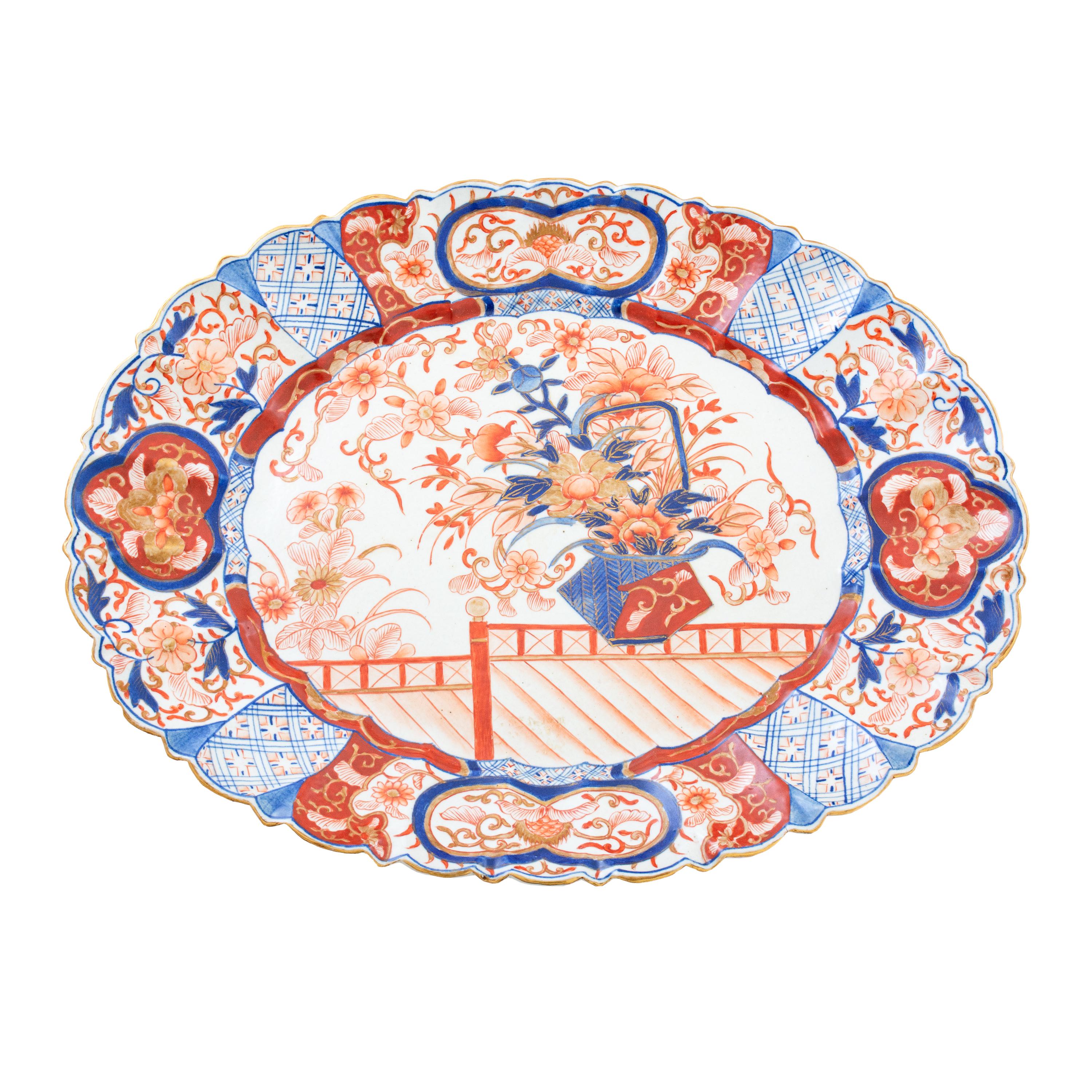 This is an exquisite, and very collectible, pair of oval Japanese Imari platters with scalloped edge and hand-painted in classic Imari colors of cobalt blue and bittersweet, 19th century. Priced individually.