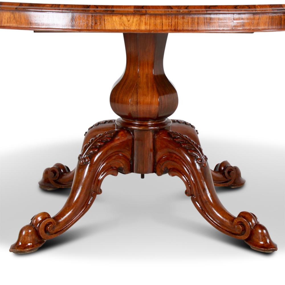 A 19th century oval table in highly-figured rosewood, the oval top raised on a single baluster column supported by four serpentine legs with scroll feet.
The table opens to take leaves but there are no leaves presently. (Leaves can be custom