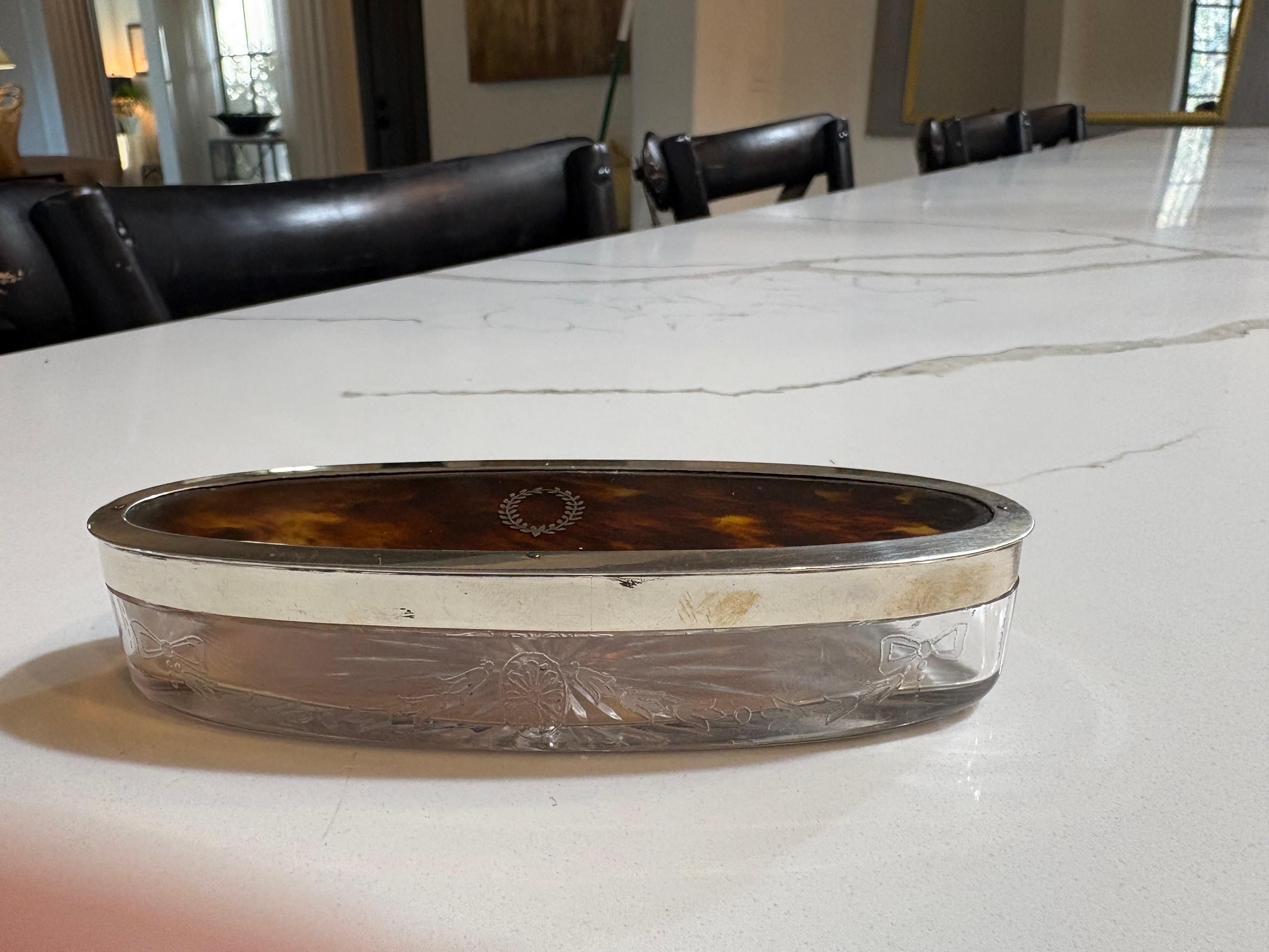 Embossed 19th century oval tortoise shell box with glass base and maker markings. For Sale