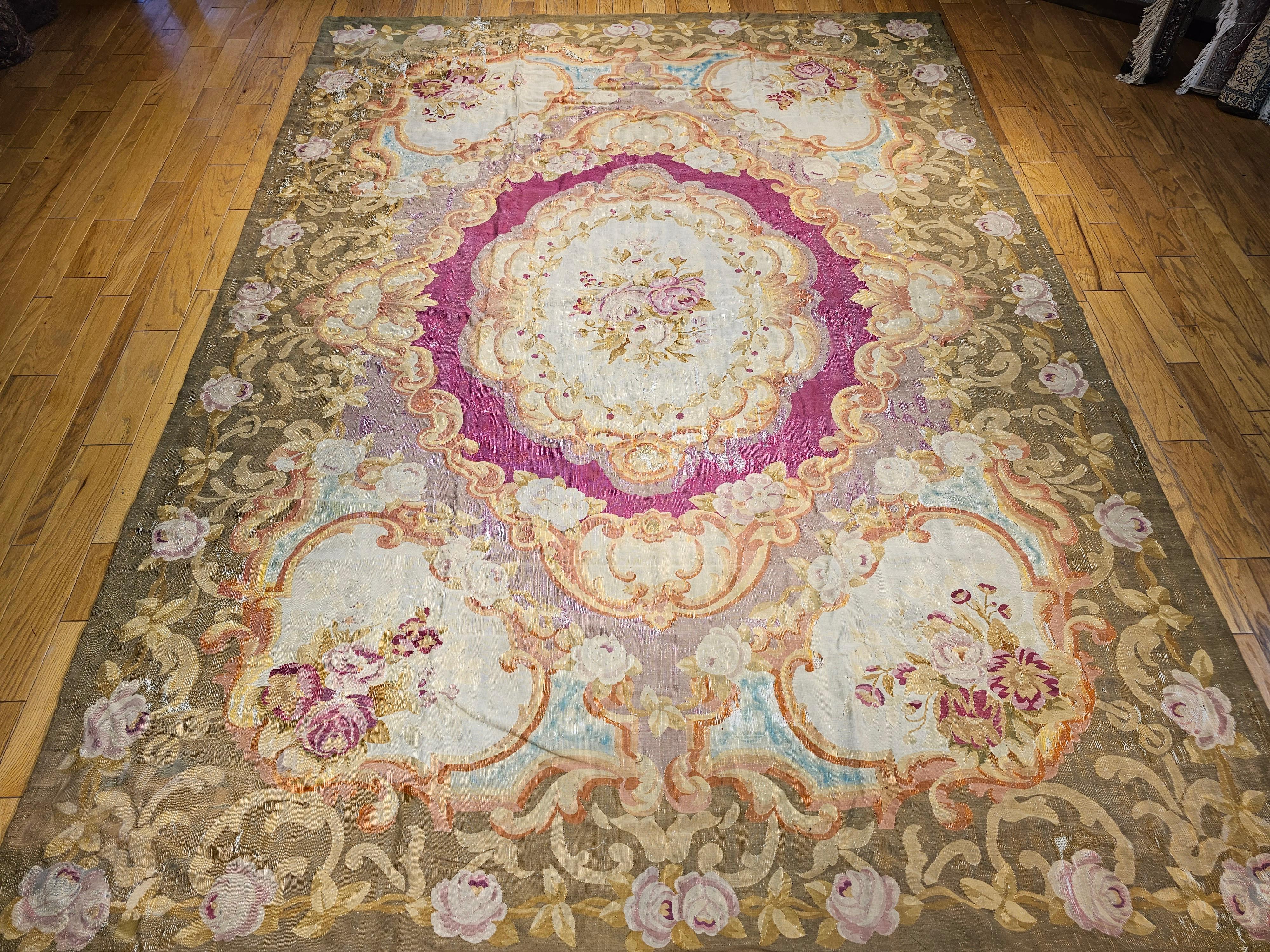  The Louis Philippe Aubusson carpet from the mid1800s (circa 1840s) has one of the most spectacular design and color combinations. A central oval floral medallion flanked by sprays on the dusty rose field is within an olive green vinery border.The