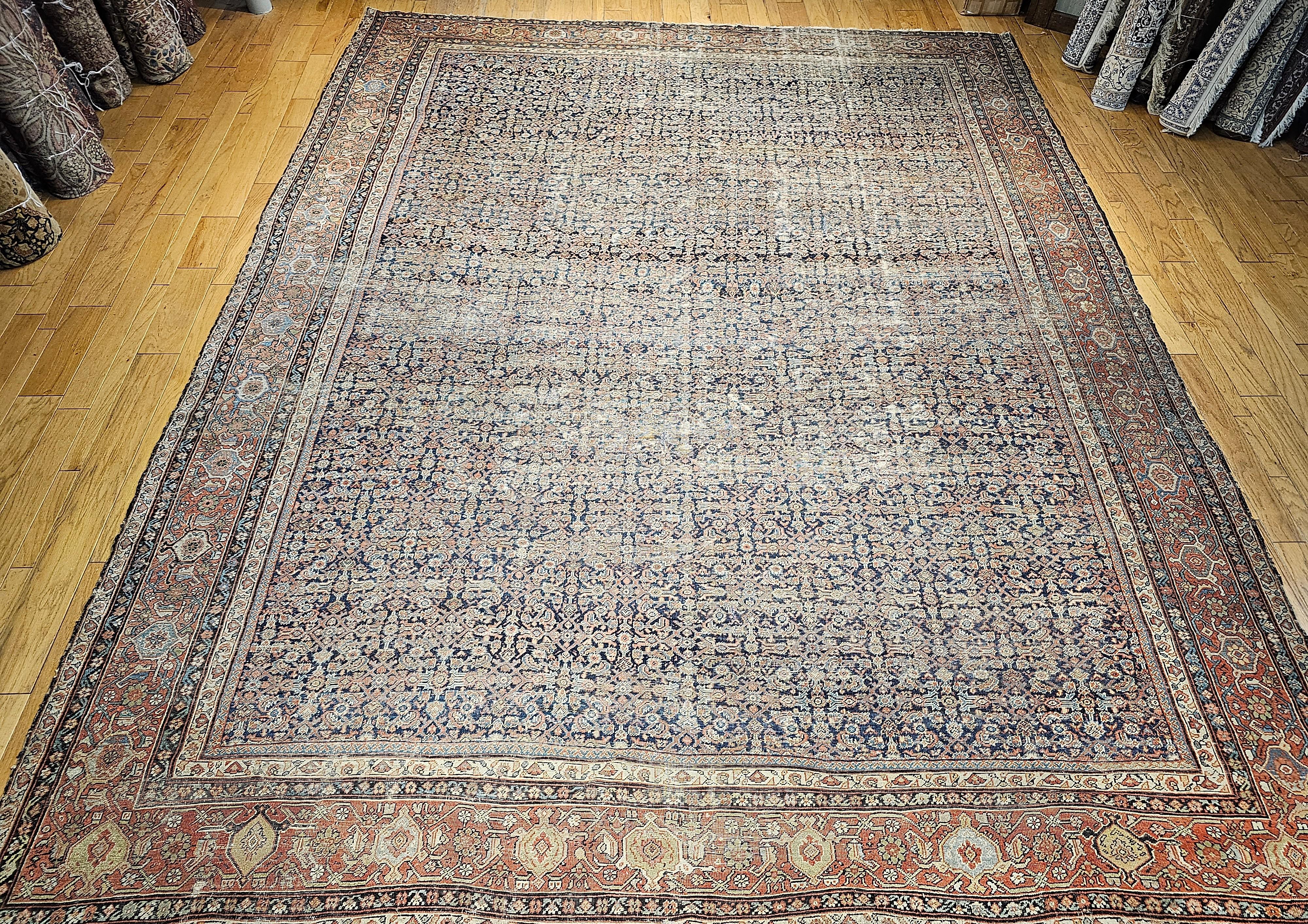 A wonderful 19th century Persian Farahan in an all-over Herati pattern in an oversized or “mansion size” in navy blue, green, blue, pale yellow.  This extremely finely hand woven Farahan rug from Western Persia has a “Herati” all-over pattern set in