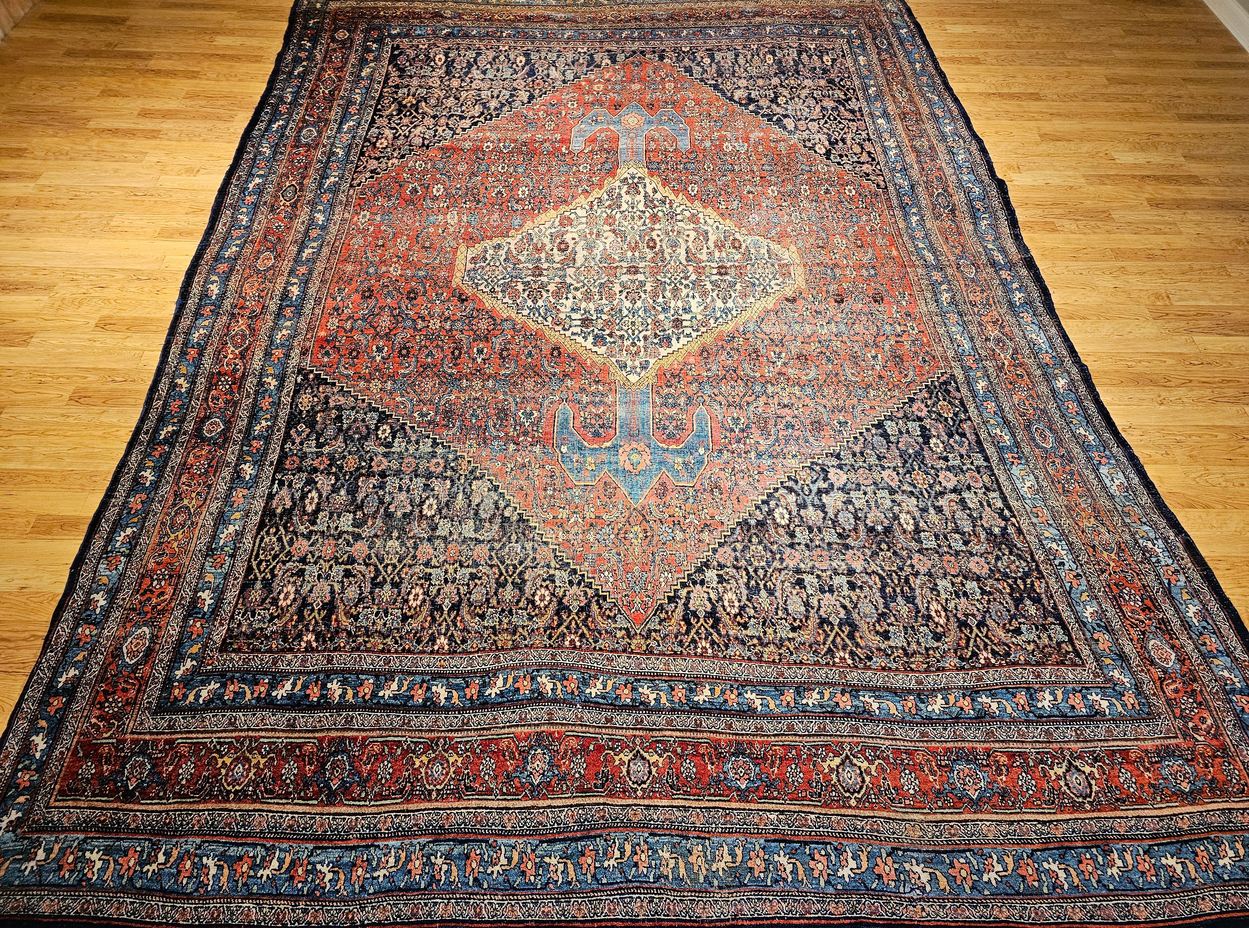 Beautiful 19th century oversized Persian Bidjar area rug with a medallion design in a Herati geometric pattern in red, French blue, ivory, navy, and yellow colors.   The rug has a combination of an abrash French blue and rich red field colors.   