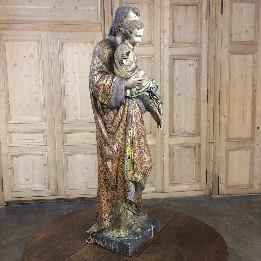 19th century solid wood hand painted and carved life-size statue of St. Joseph & Baby Jesus represents an incredible work of art from both the sculptor's perspective, as well as that of the artist! The expressions and poses of Jesus and Joseph are