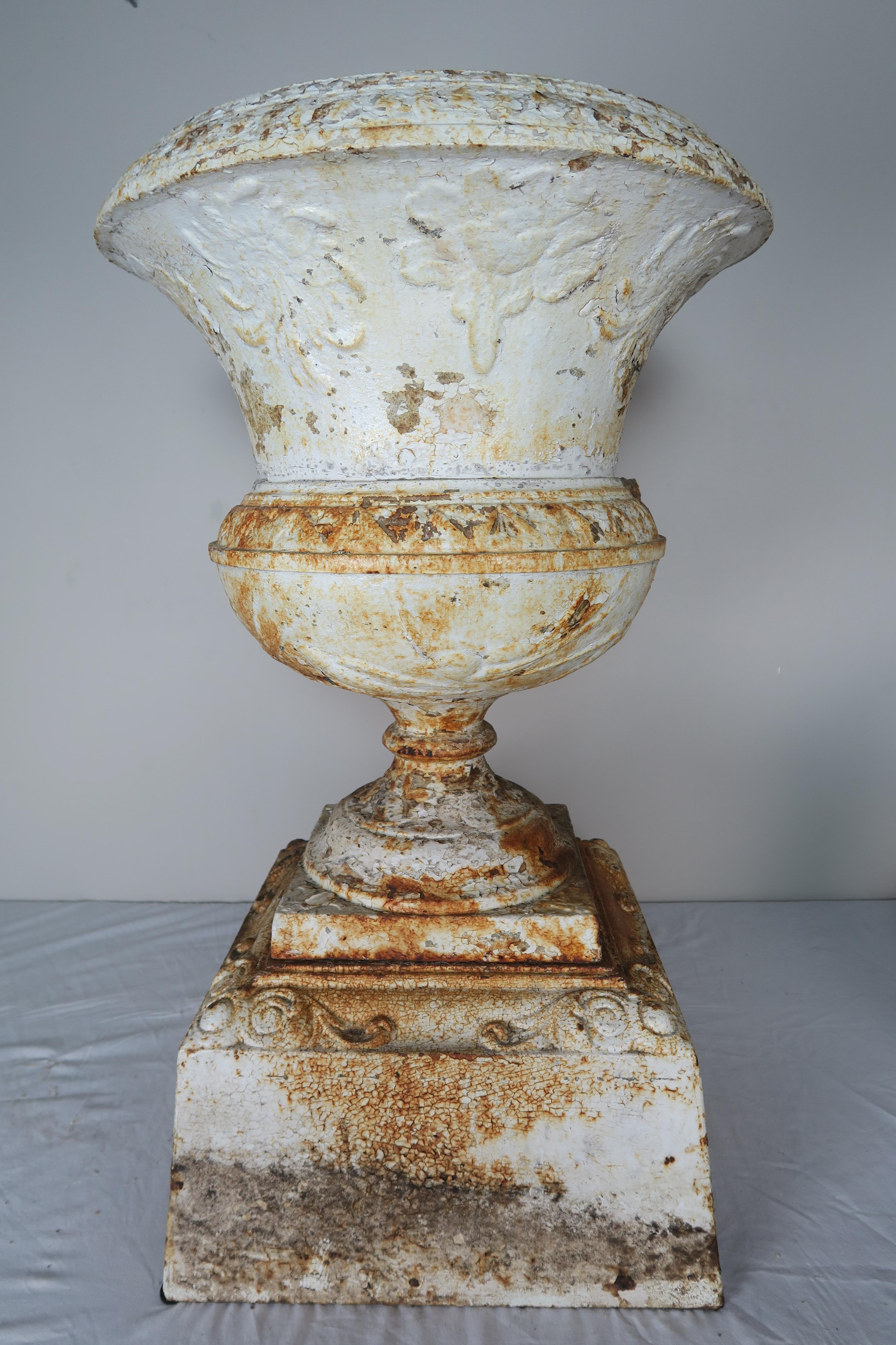 19th century French painted cast iron garden urn with beautiful weathered finish.